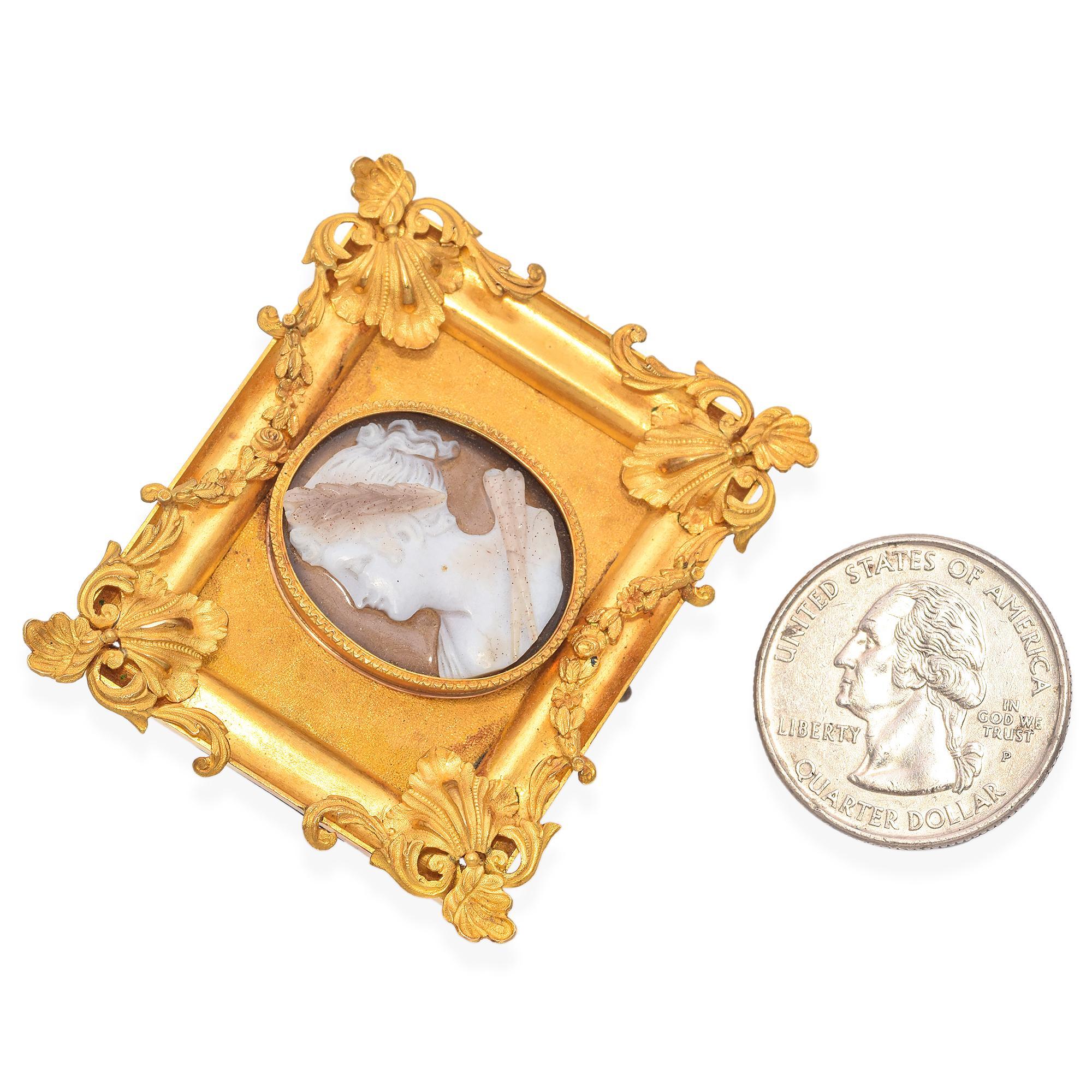 Exquisite Antique Gold Framed Cameo Brooch. This elegant brooch features a finely carved cameo set in a lavish gold frame. The cameo depicts a classical profile, intricately detailed with a laurel wreath and draped garment. The frame is adorned with