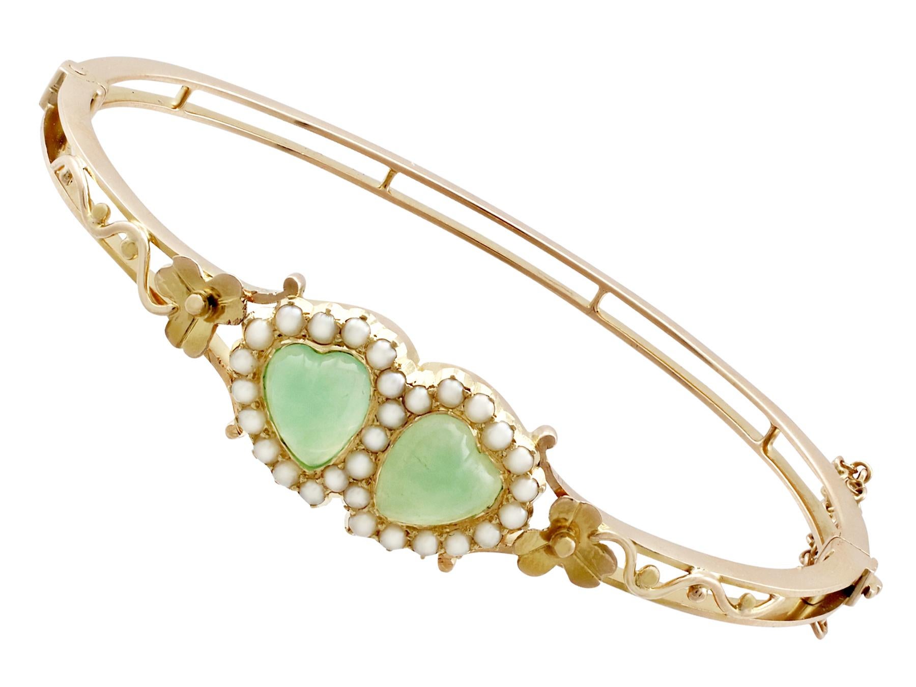An impressive antique Victorian 2.20 carat chrysoprase and seed pearl, 15 karat yellow gold bangle; part of our diverse antique jewelry and estate jewelry collections.

This fine and impressive antique bangle has been crafted in 15k yellow