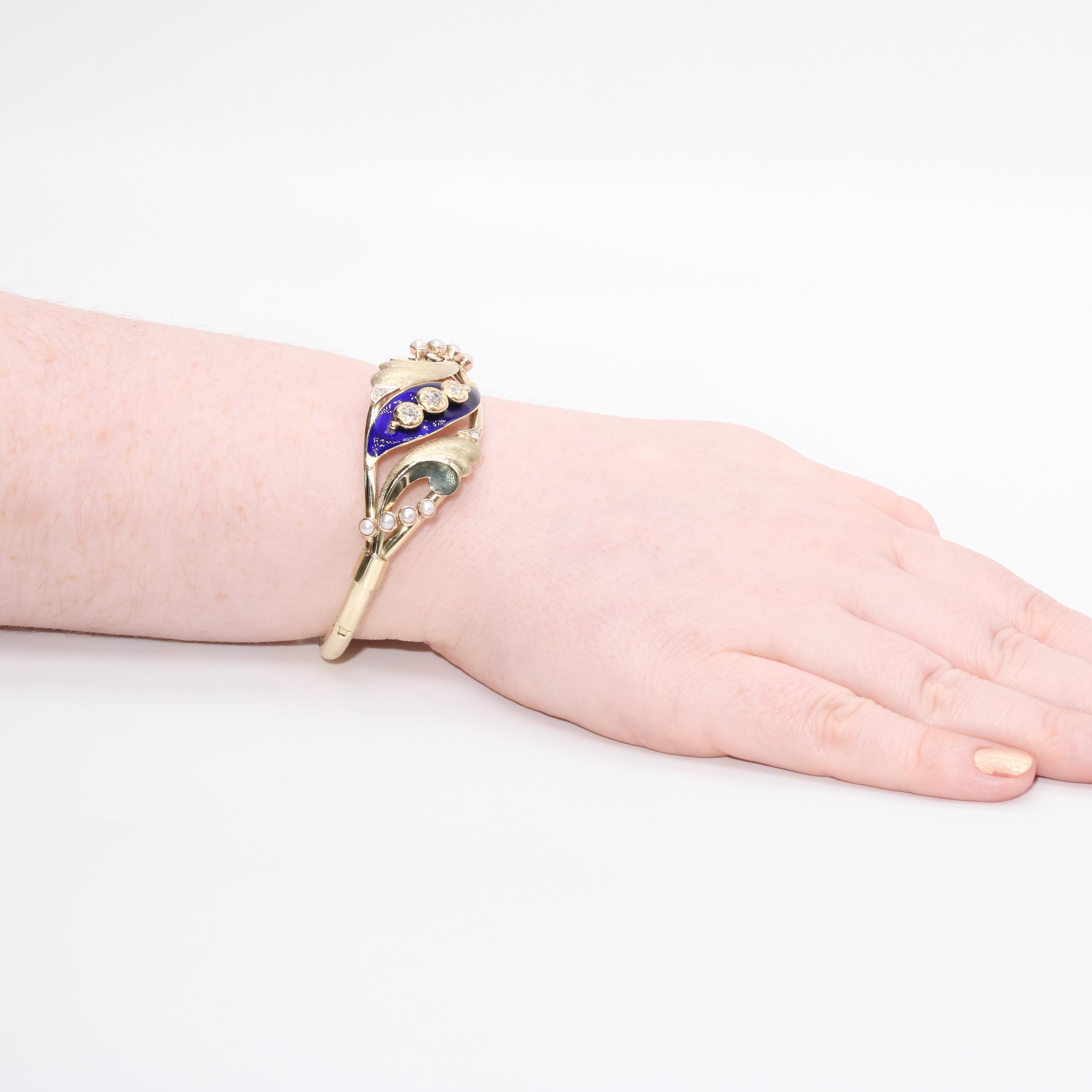A Victorian, diamond, pearl, enamel, and gold bracelet, comprising five old cut diamonds, eight seed pearls, and blue enamel, set in 14 karat yellow gold. 

This beautiful bracelet has a central leaf-shaped panel, which is adorned in cobalt blue