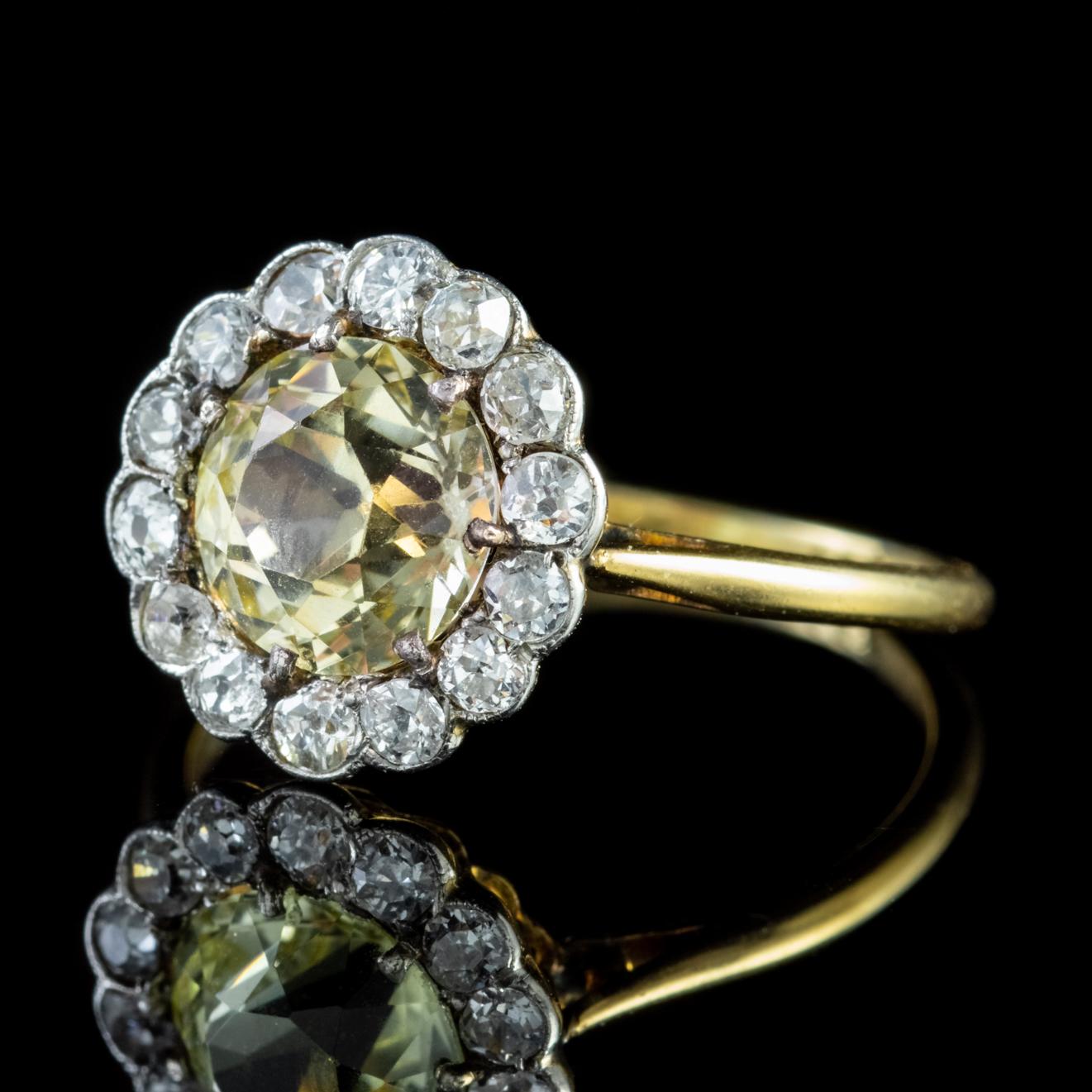 This stunning Antique Victorian ring has been expertly crafted around a 2ct cushion cut yellow Sapphire. The central stone is encircled by a halo of fourteen old cut Diamonds, approx. 0.05ct each, 0.7ct in total. 

The Yellow Sapphire boasts a