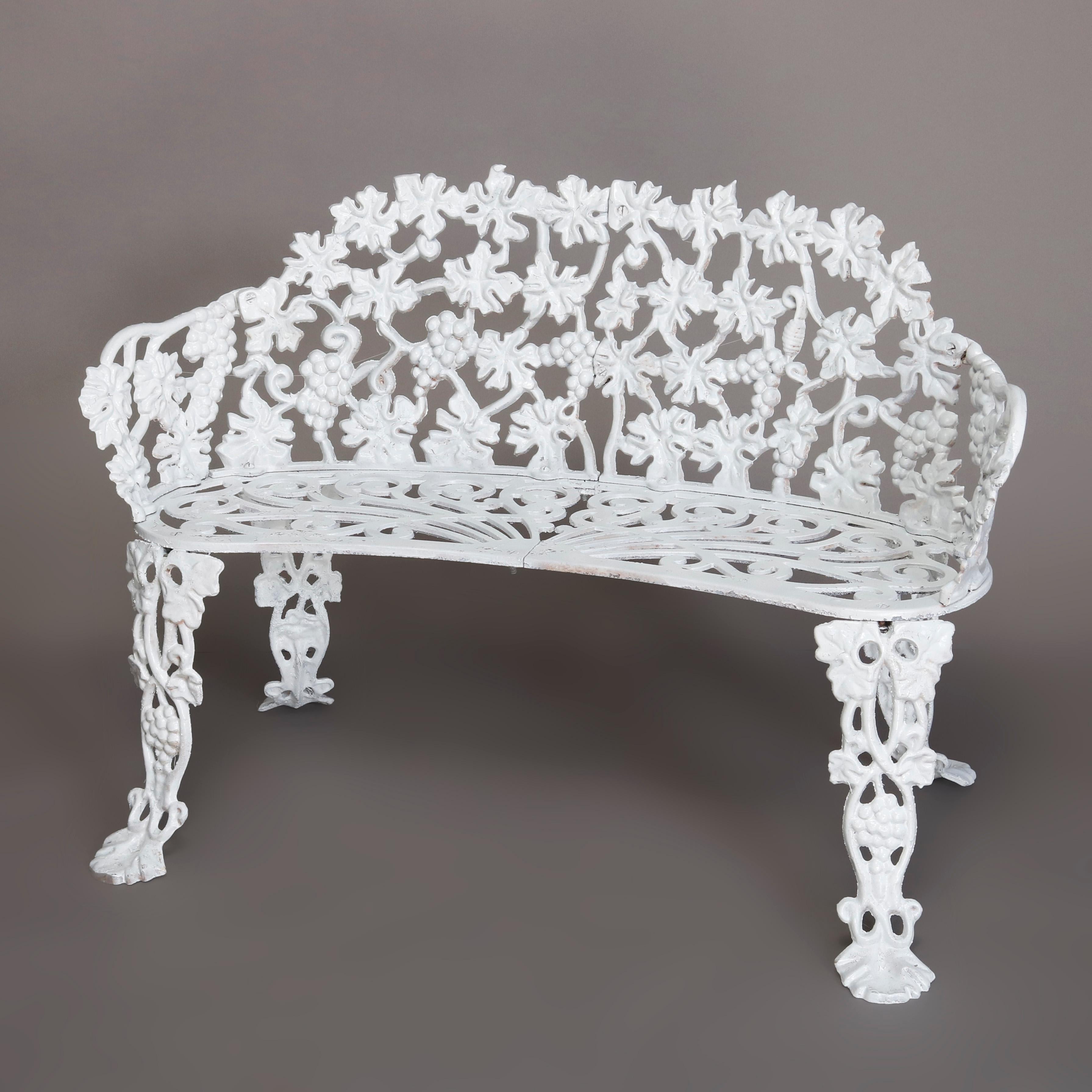An antique Victorian 3-piece garden seating set by Hart offers painted white cast iron construction in grape and leaf form and includes settee, armchair and table, marked Hart on back and Atlanta Stove Works on bench underside, circa