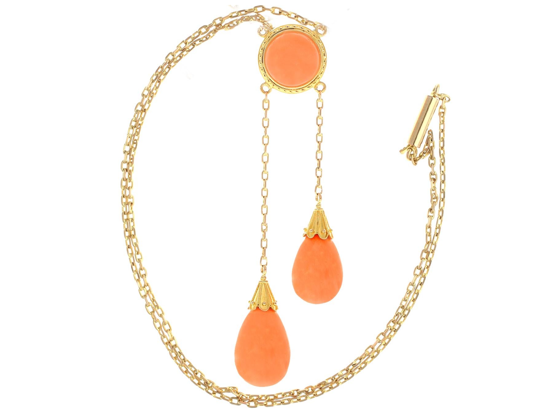 A stunning antique Victorian 1870s 35.22 carat coral and 12 karat yellow gold drop necklace; part of our diverse antique jewelry and estate jewelry collections.

This stunning, fine and impressive Victorian cabochon cut necklace has been crafted in