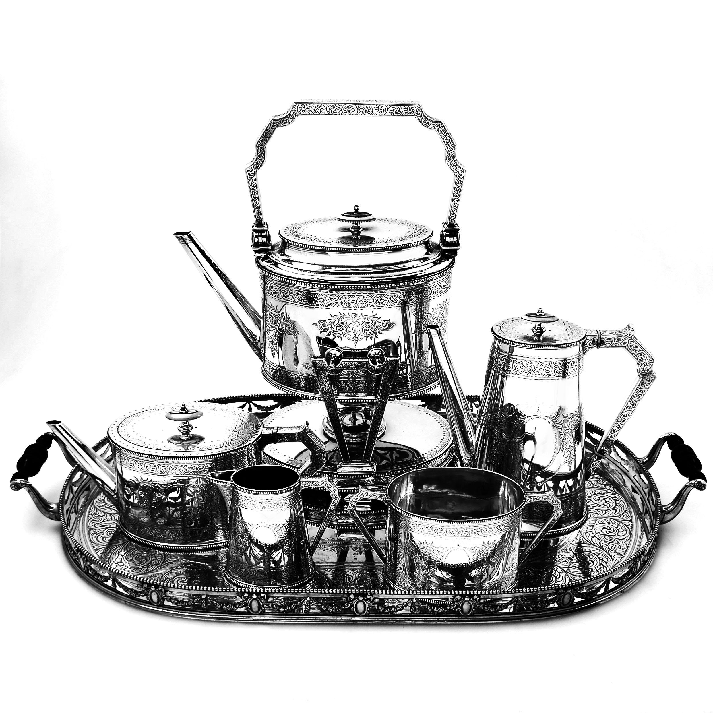 A magnificent Antique Victorian Sterling Silver Tea and Coffee Set on an impressive matching Tray. The Set comprises of a tea pot, coffee pot, hot water kettle on stand with original burner, a milk / cream jug, sugar bowl and large serving tray. The