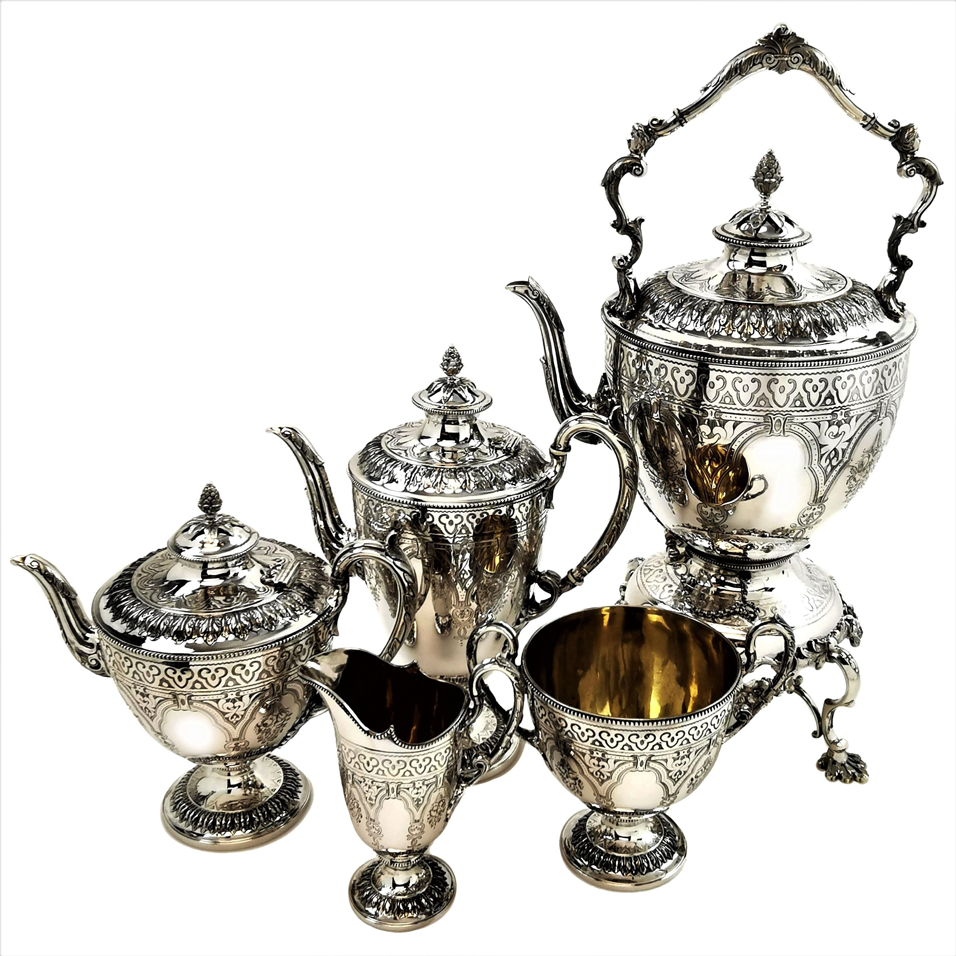 A magnificent antique Victorian sterling Silver Tea and Coffee set comprising of a Kettle on Stand, Tea Pot, Coffee Pot, Cream / Milk Jug & Sugar Bowl. Each piece of this vase shaped tea set is decorated with an elegant chased and engraved design.