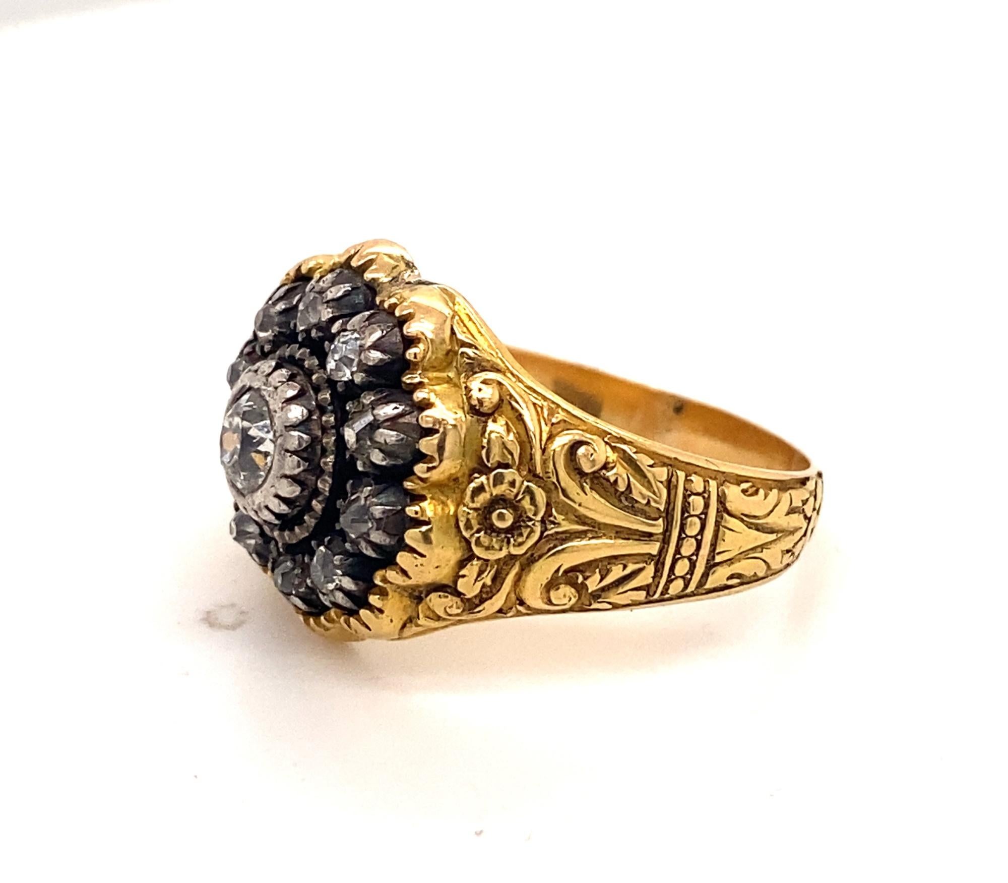 This is a stunning antique late Victorian c.1910 Men’s ring with floral Art Nouveau designs on the side.  The ring is set with a .50 carat old mine cushion cut and 10 rose cut diamonds set in platinum.  The floral and scroll work is finely detailed.