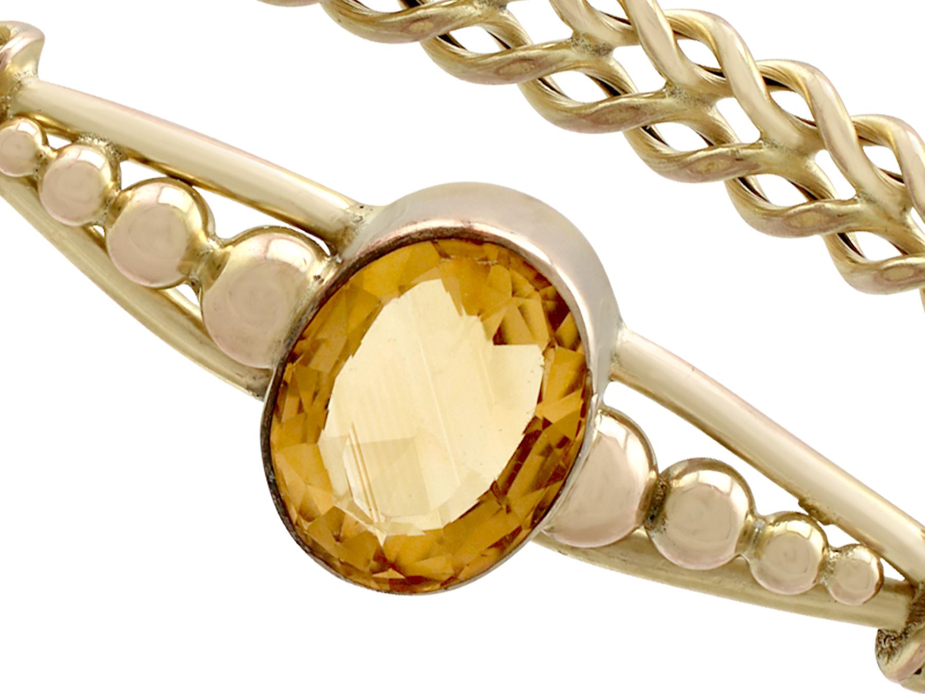 An impressive antique Victorian 5.05 carat citrine and 9 karat yellow gold bangle; part of our diverse antique jewelry and estate jewelry collections.

This fine and impressive antique bangle has been crafted in 9k yellow gold.

The anterior face of