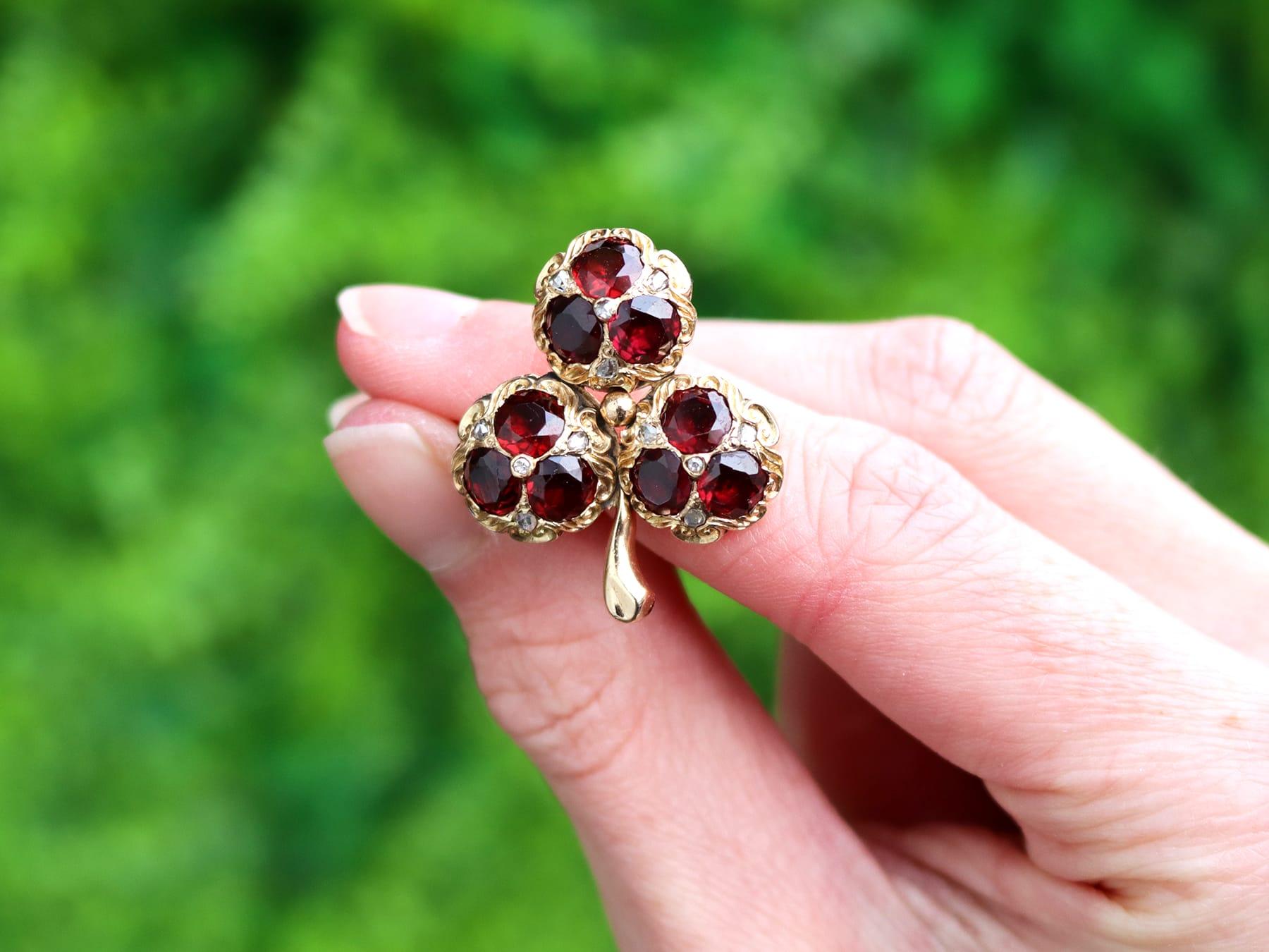 An exceptional antique Victorian 5.20 carat garnet and 0.11 carat diamond, 15k yellow gold 'clover' brooch; part of our diverse antique jewelry and estate jewelry collections.

This exceptional, fine and impressive Victorian garnet brooch has been