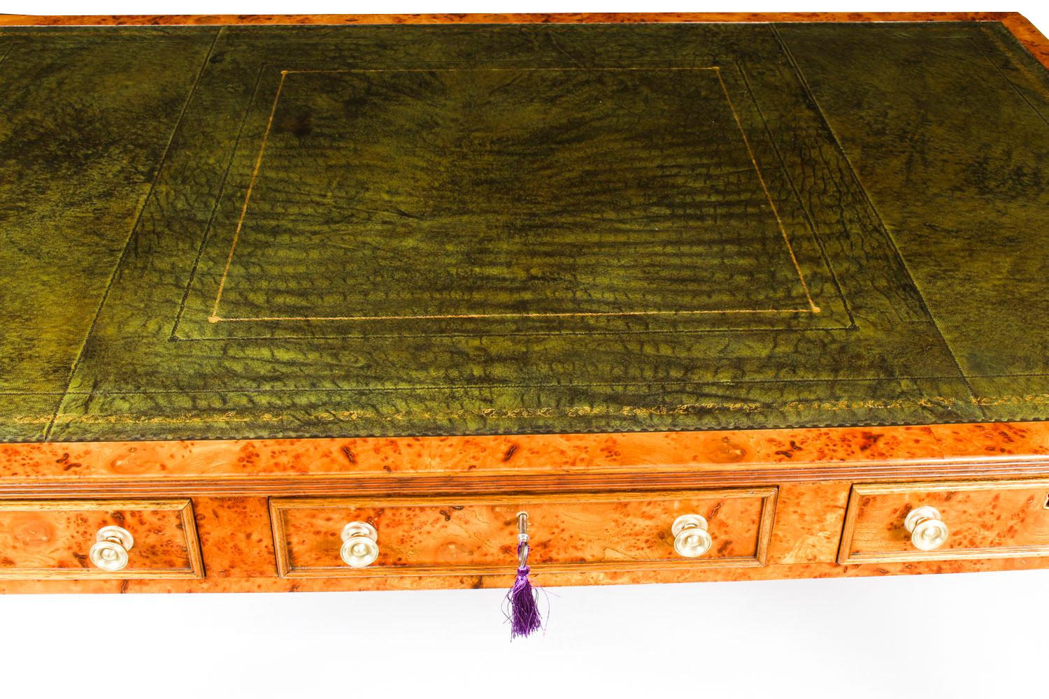 This gorgeous early Victorian antique Partners desk is crafted from beautiful pollard oak and dates from circa 1850.

It features a striking olive green inset leather writing surface that has beautiful hand tooled gilt decoration. It is raised on