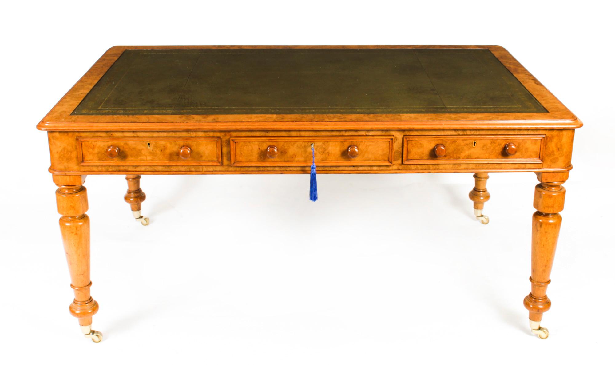 This gorgeous early Victorian antique Partners desk is crafted from beautiful pollard oak and dates from Circa 1860.

It features a striking olive green inset leather writing surface that has beautiful hand tooled gilt decoration. It is raised on