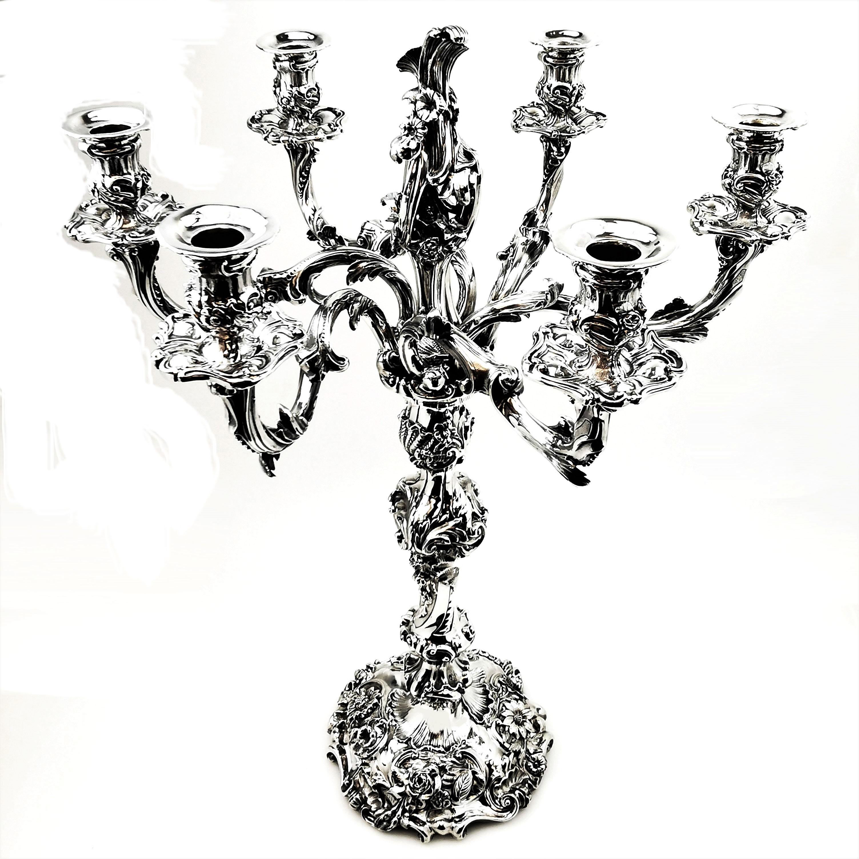 An impressive Victorian solid Silver Candelabrum with an ornate chased and applied floral design. This magnificent candelabra has 6 spread branches embellished with stylised leaf designs leading into floral tops. The centre of the Candelabra has an