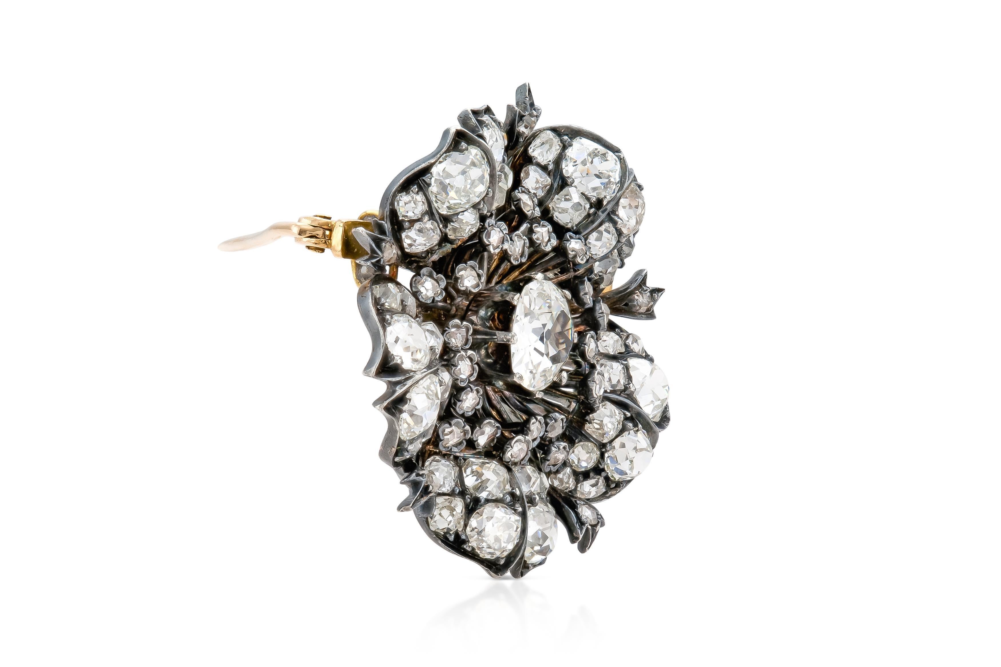 Finely crafted in silver on top of yellow gold with an Old Mine cut center Diamond weighing approximately 1.60 carats.
The brooch features smaller Old Mine cut Diamonds weighing approximately a total of 6.00 carats.
All diamonds are of H-I color,