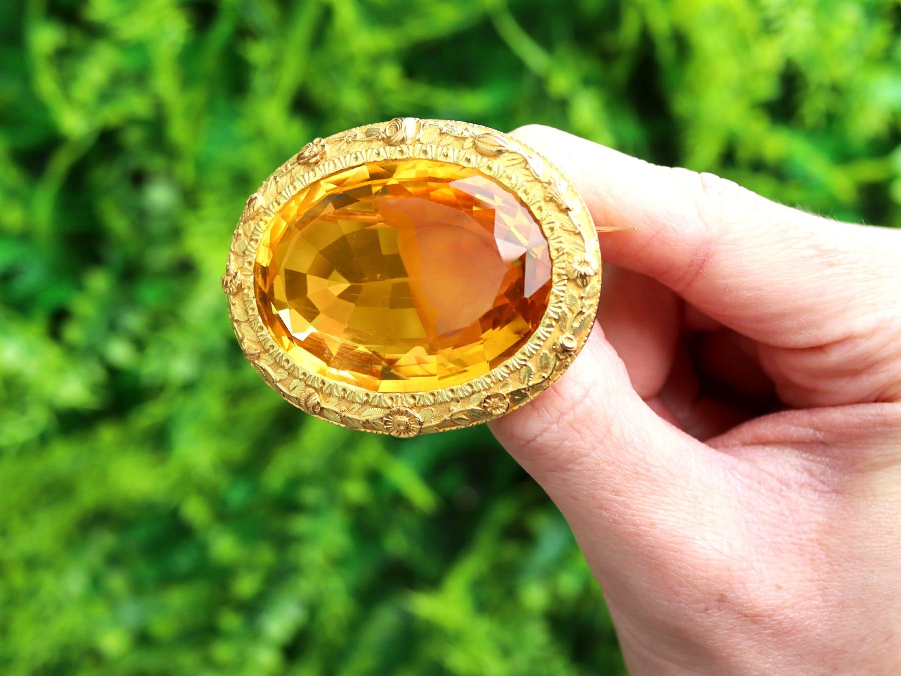 A stunning, fine and impressive, large antique Victorian 85.49 carat citrine and 18 karat yellow gold brooch; part of our diverse antique jewelry and estate jewelry collections

This stunning and large Victorian brooch has been crafted in 18k yellow