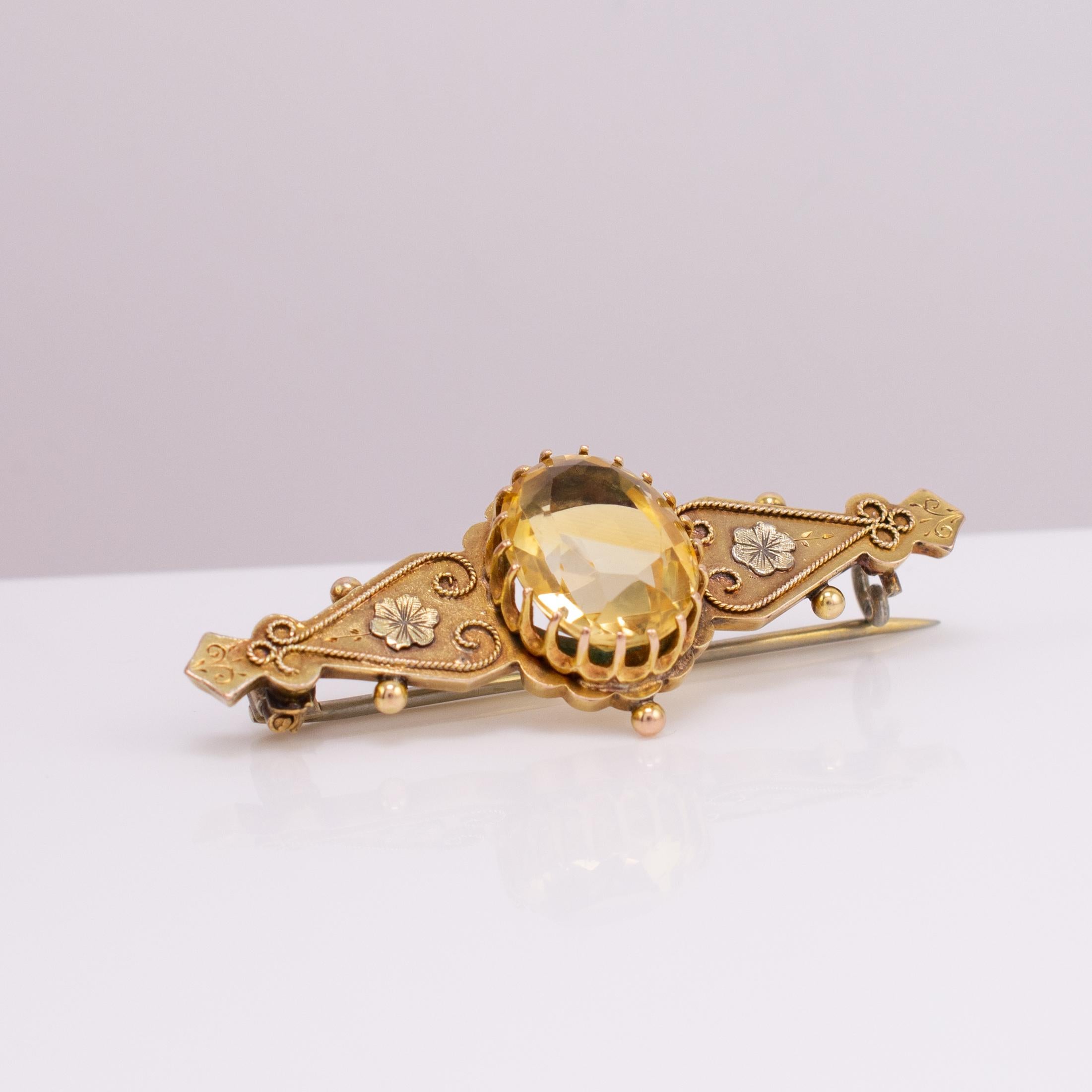 The most beautiful Victorian period citrine brooch with Cannetille flowers and scrolls.

The large claw set 6 carat oval facet cut yellow citrine is beautifully eye catching and displays translucent shades of golden yellow . The reverse has open