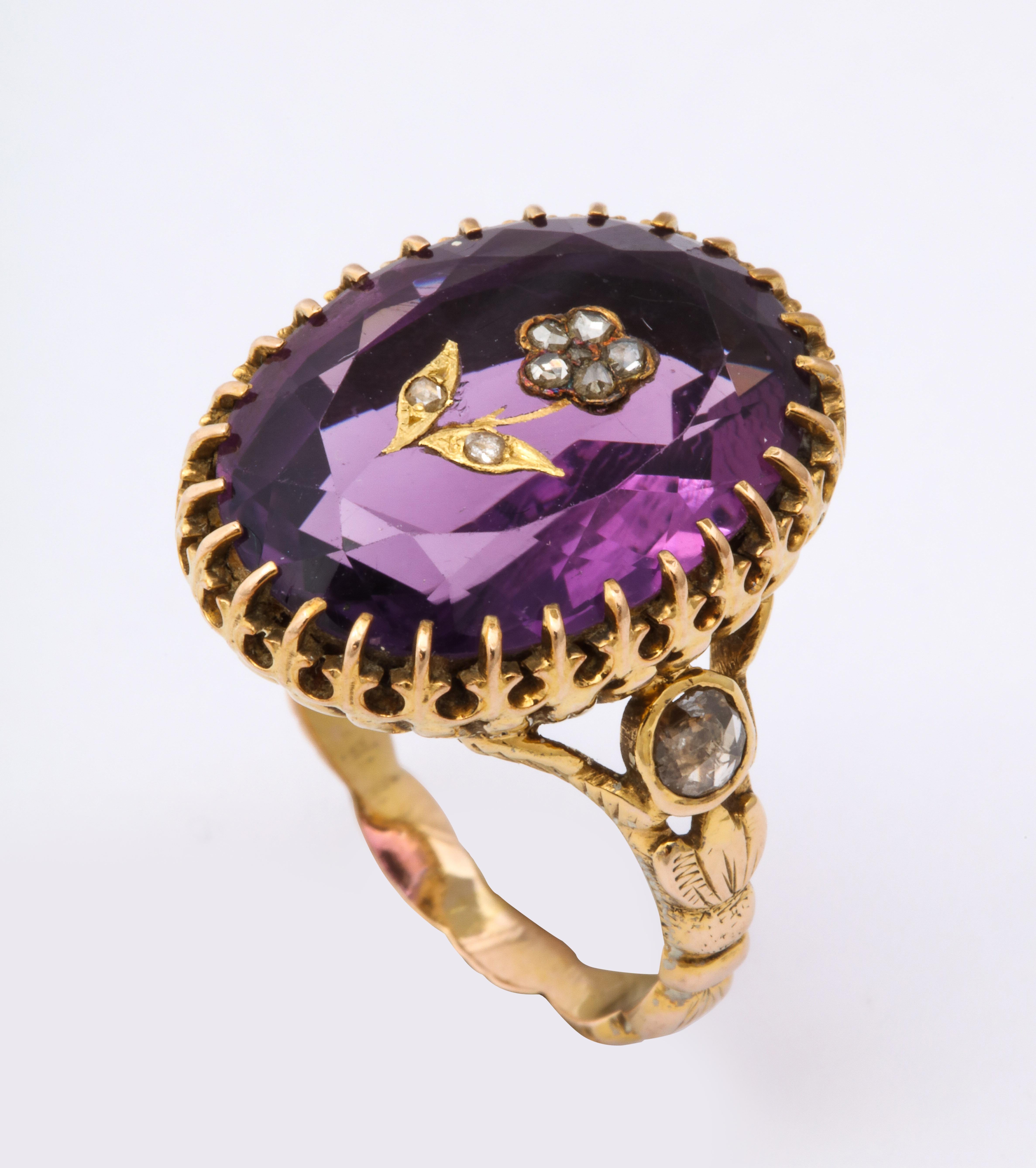 Glowing adjectives are necessary because this is an exquisite, gem amethyst ring of 9 1/2 ct, center set with gold for-get-me not flower with diamond petals. There are two accent .3 diamonds on the shoulders. Sumptuous 15 Kt. gold on the girdle and