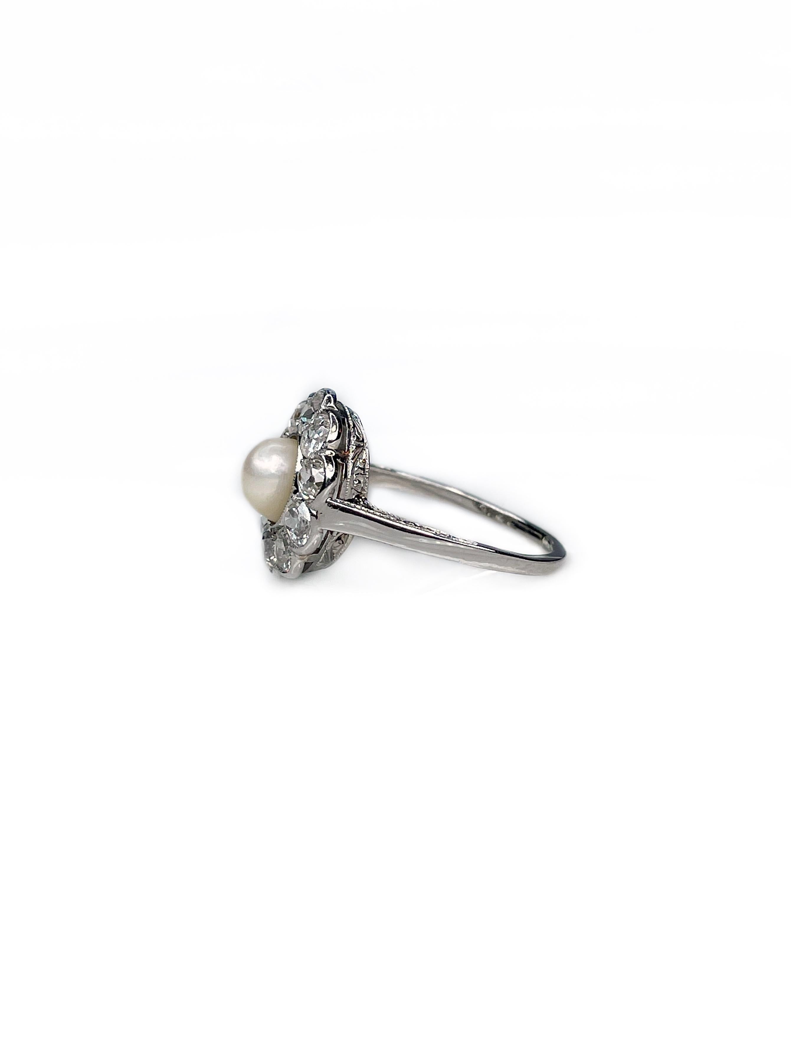 This is a beautiful flower shape cluster ring crafted in 950 hallmark platinum. It is dating from a Victorian period. 

The piece features a cultured pearl in the center. It is surrounded by 10 old cut diamonds, which in total weight 1ct, colour is
