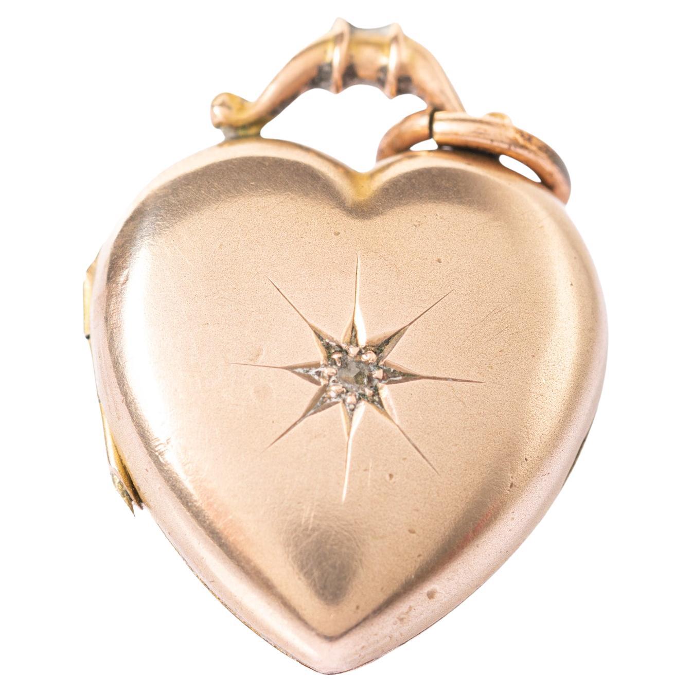 This charming antique Victorian heart diamond locket is crafted in 9ct yellow gold back and front. The locket is decorated with a star motif with a diamond at its heart. The star motifs were very popular in the Victorian period and they are a symbol