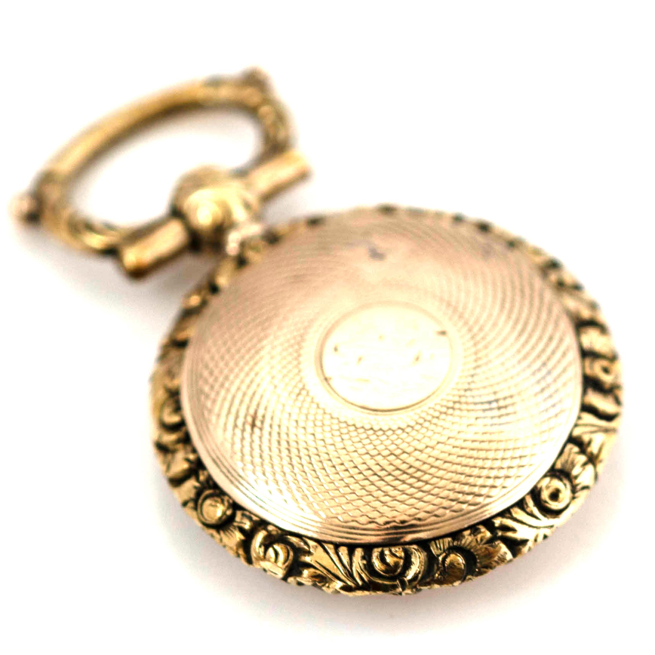 Step back into the deep sentimentality of the Victorian era with this poignant 9ct gold mourning locket. Masterfully crafted with an engine-turned technique, the intricate patterns on its surface reflect the period's dedication to fine detail and