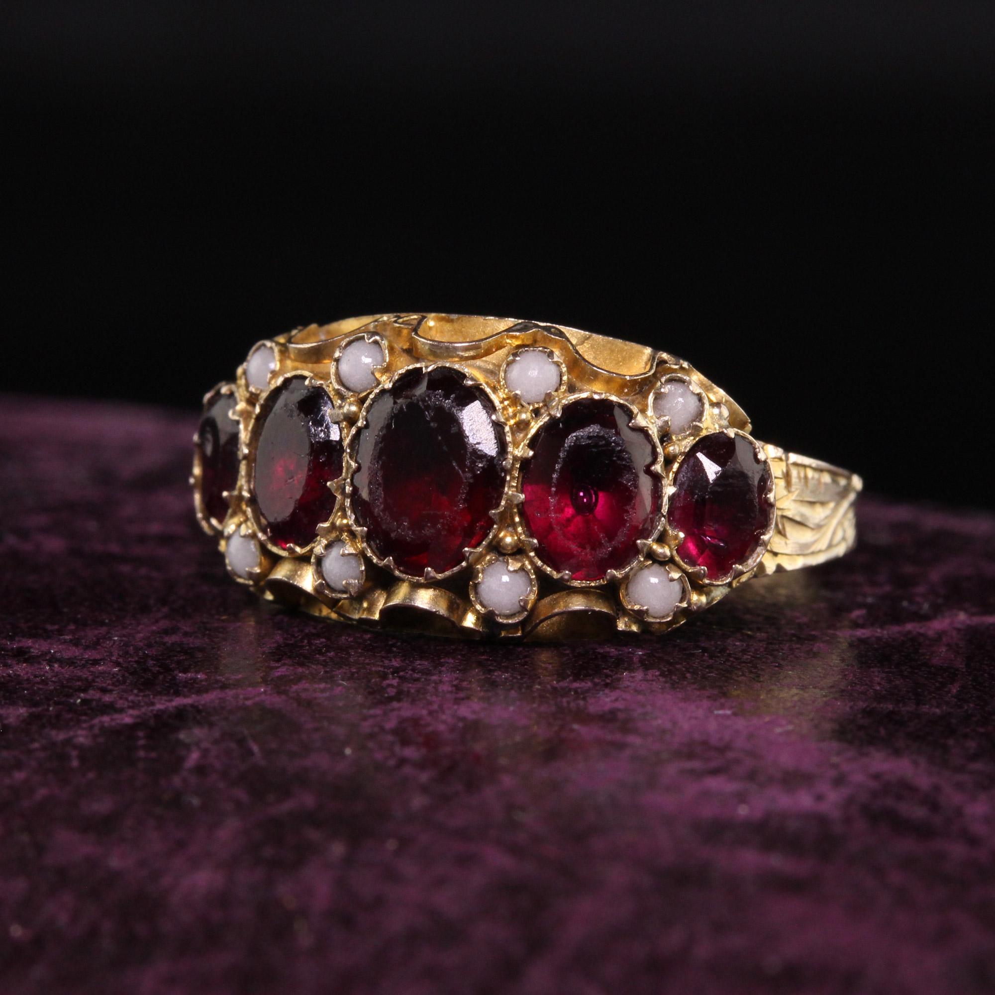 Beautiful Antique Victorian 9K Yellow Gold Garnet and Seed Pearl Five Stone Ring. This beautiful Victorian ring is crafted in 9k yellow gold. It has garnets and seed pearls set in a beautifully engraved Victorian mounting and is in good
