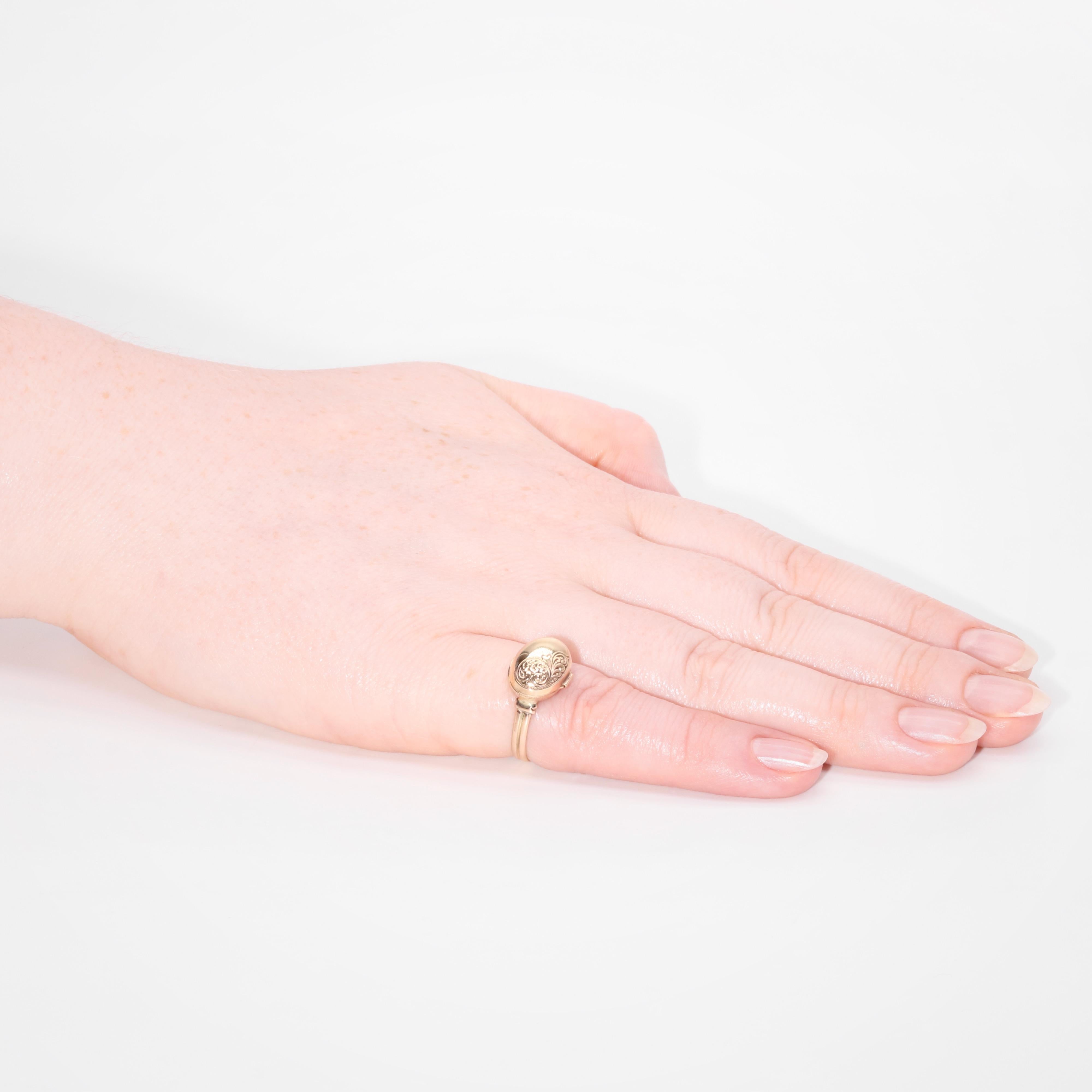 An antique yellow gold ring, comprising one oval shaped locket compartment, in 9 karat yellow gold, to a band of 9 karat yellow gold. 

This amazing ring is set to the centre with an oval shaped head, which is beautifully tactile, like a smooth