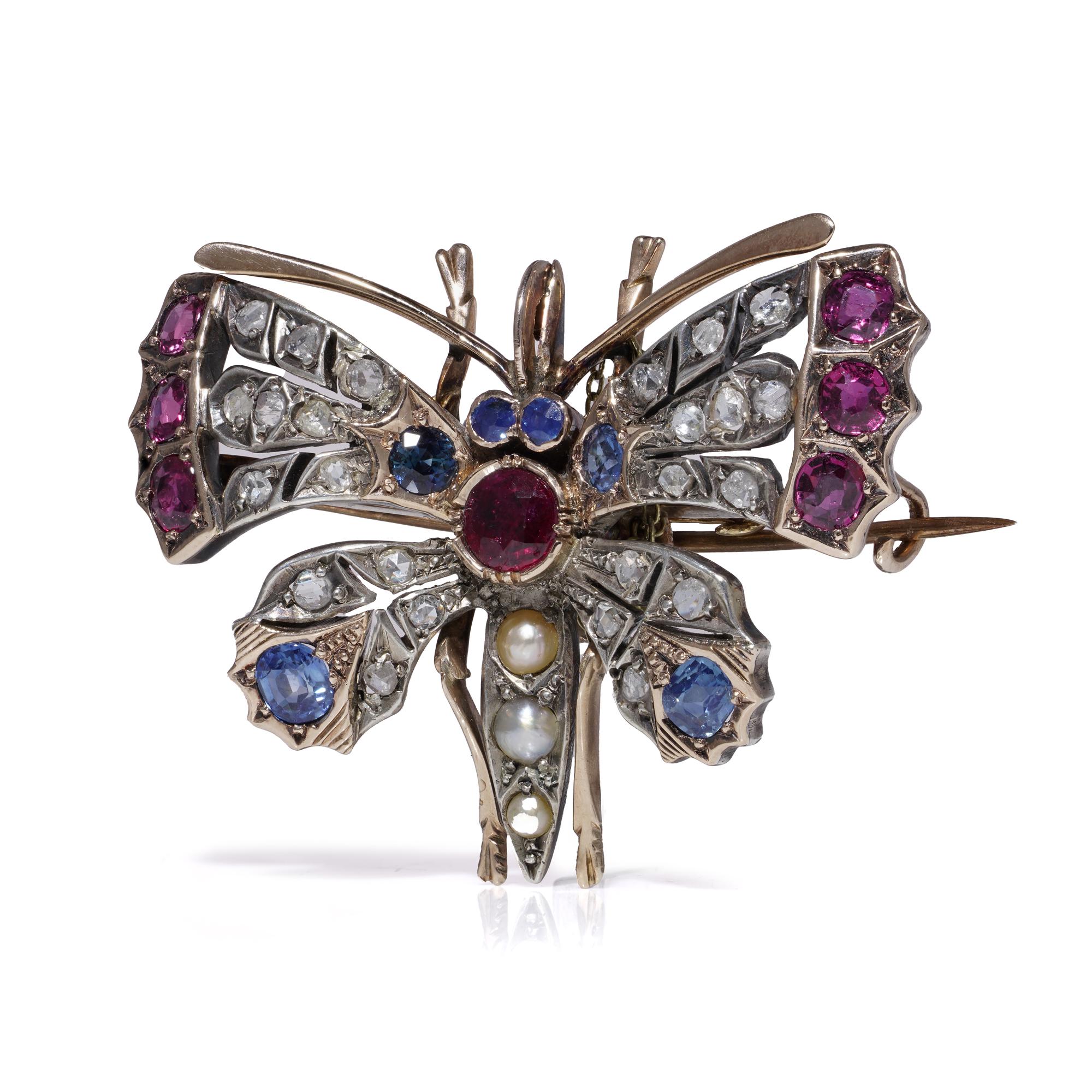 Antique Victorian 9kt Gold & Silver Butterfly Brooch with Rubies, Sapphires, Diamonds & Pearls

Description:
A delightful Victorian butterfly brooch c.1880s, masterfully set in 9kt gold and silver. The brooch is lavishly decorated with natural