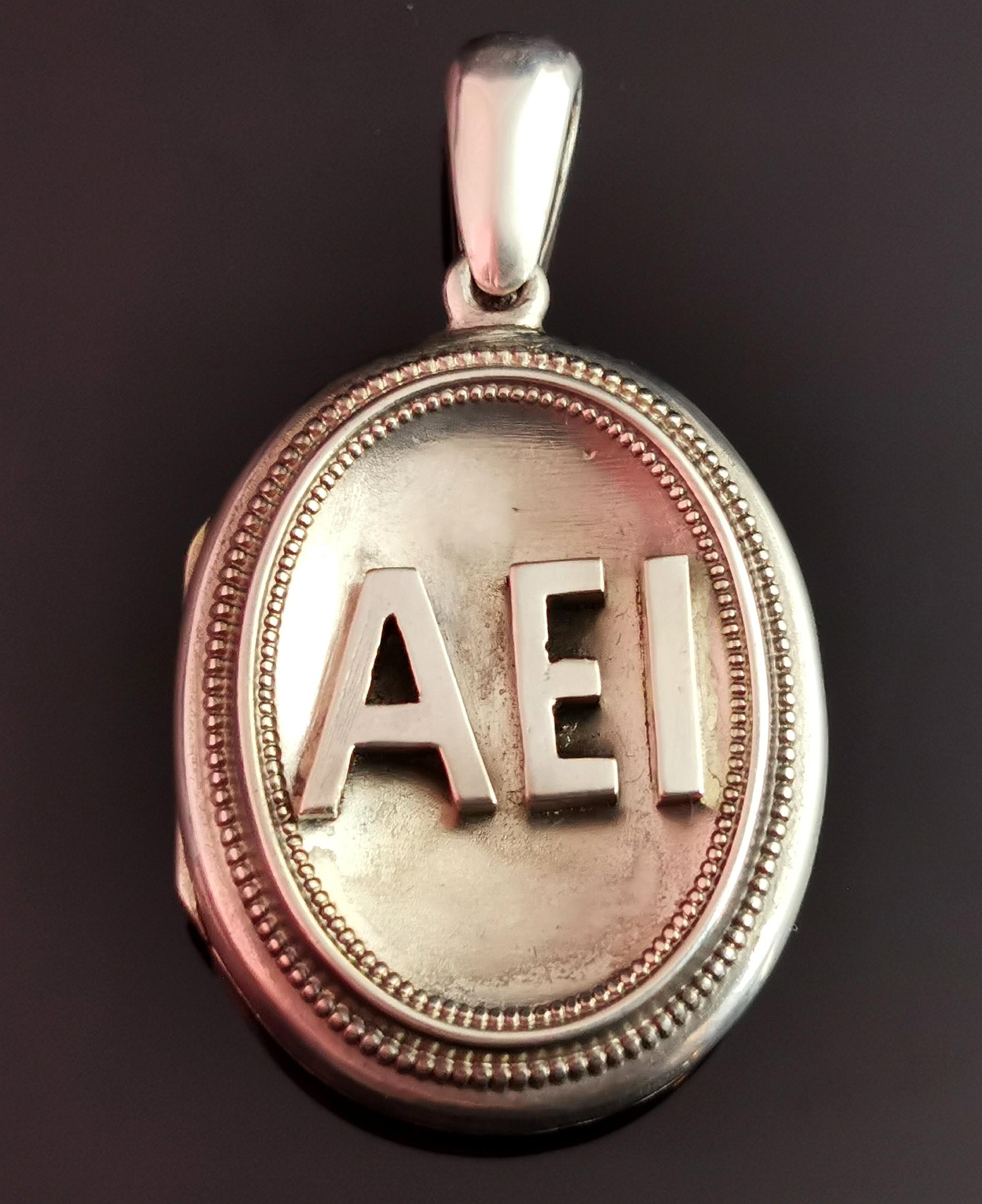 A stunning antique Victorian sterling silver AEI locket pendant.

This is a really unusual example, normally we see the letters in fancy or gothic script but this locket has these strong, chunky and bold applied letters giving a 3d effect.

It