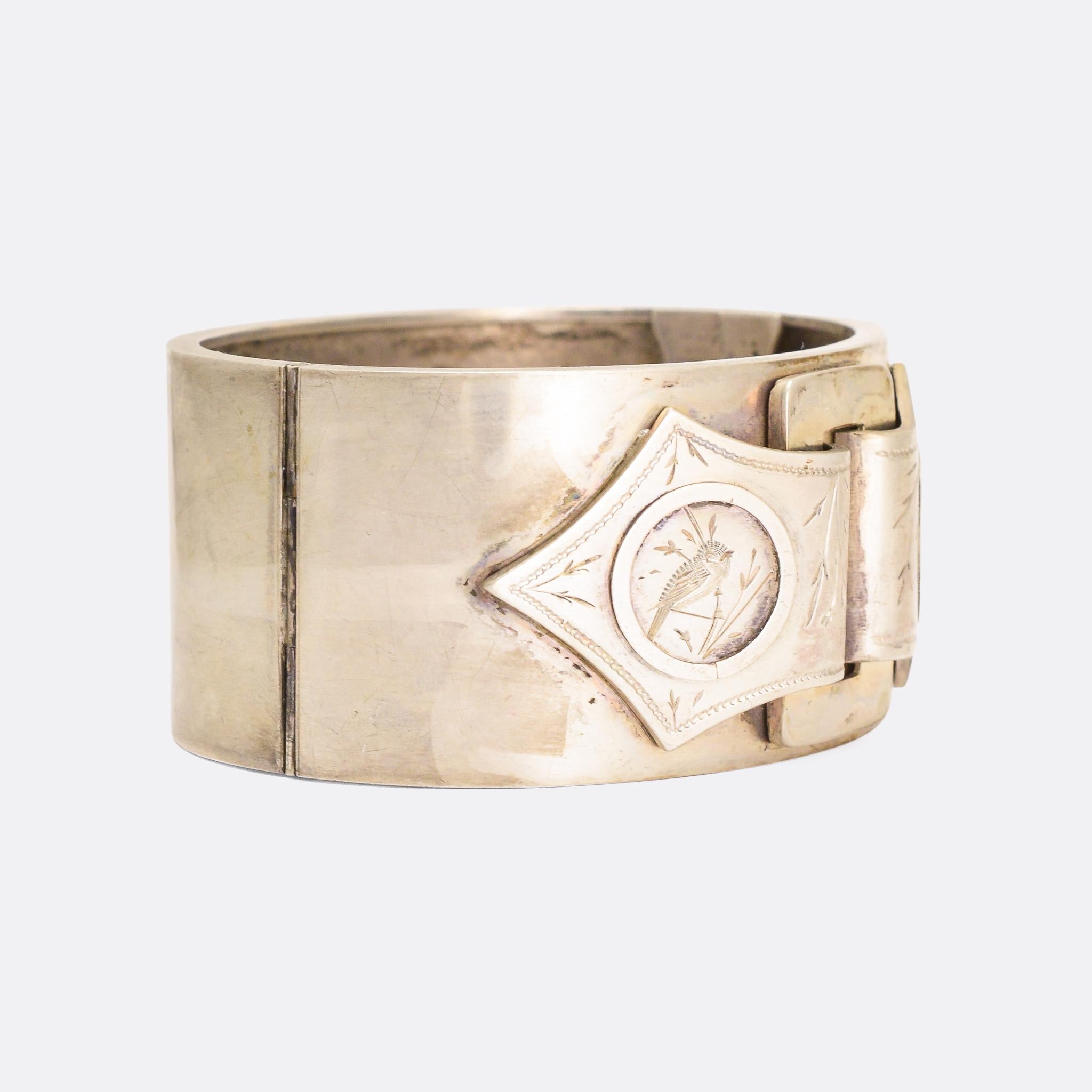 An unusual Aesthetic Movement silver cuff bangle dating from the 1880s. It features a buckle design, that has been delicately hand-chased with Japanese style birds and foliage. Modelled in Sterling Silver.

MEASUREMENTS 
Width: 3.2cm
To fit wrist: