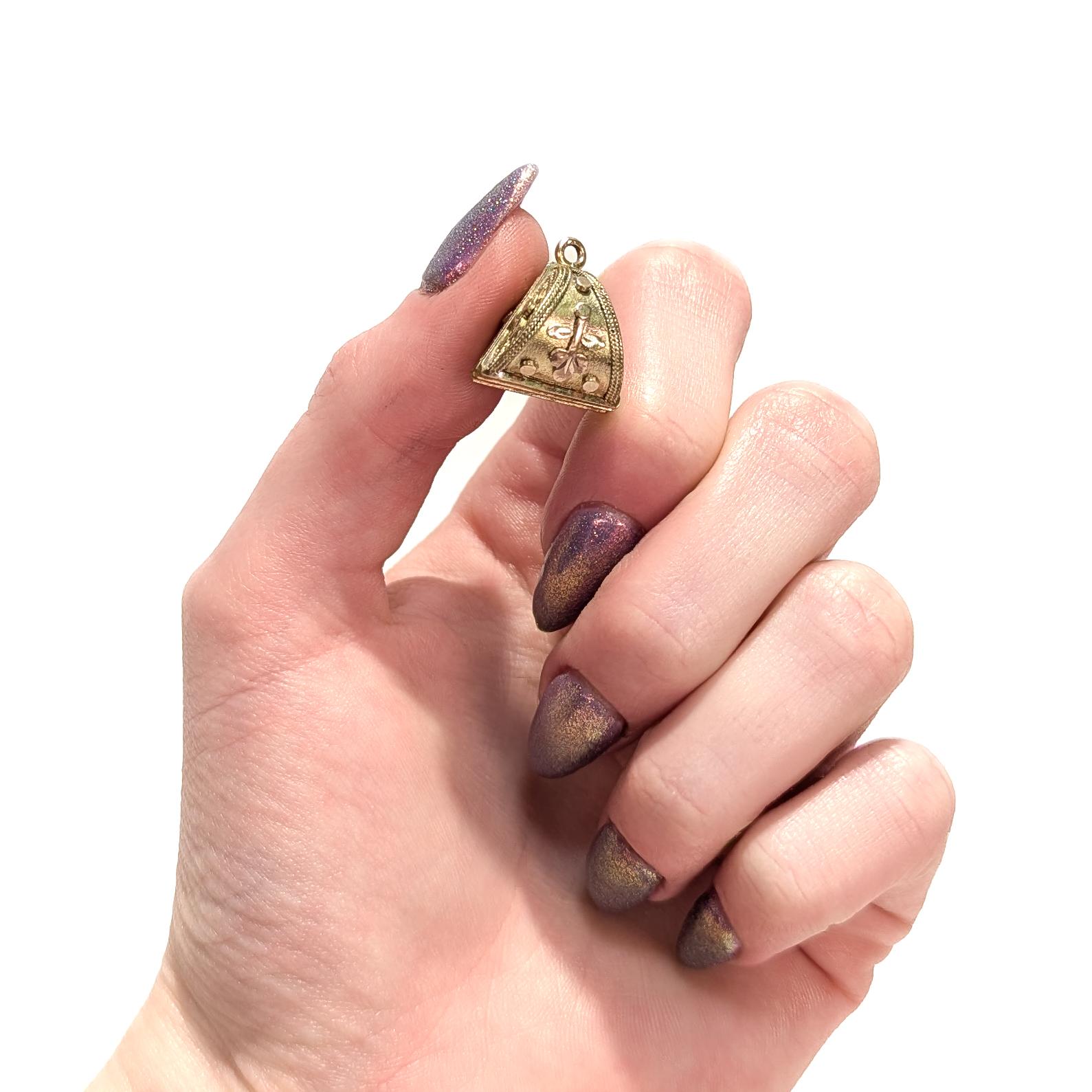 A fine antique watch fob pendant or charm.

With a two-tone gold-filled body in a triangular form.

With applied wirework and embossed decoration throughout.

Having a fixed integral bail.

Simply a wonderful Victorian or Aesthetic Movement