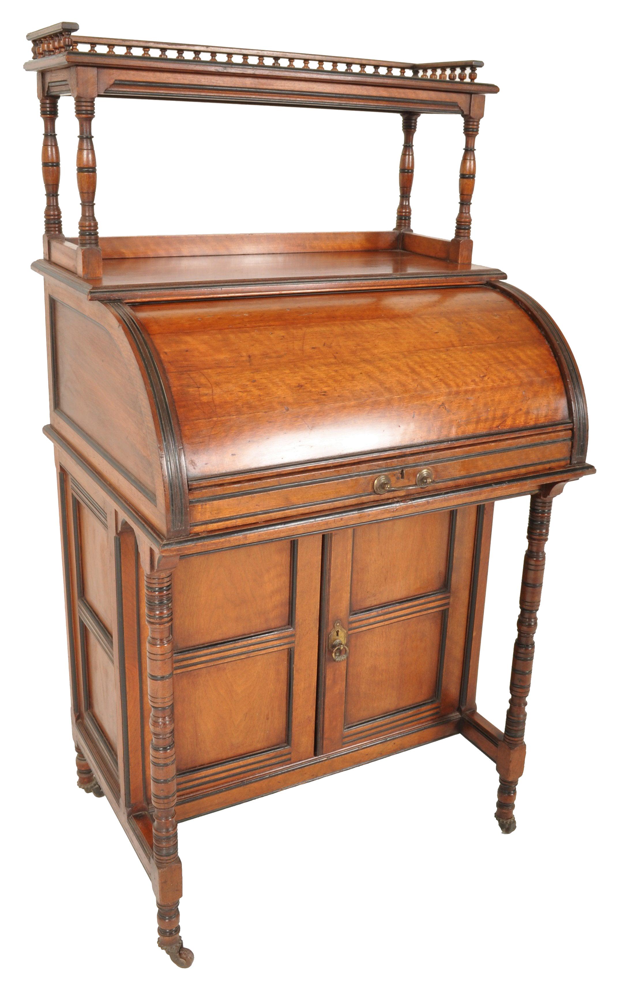 Antique Victorian aesthetic movement walnut cylinder davenport desk, circa 1875. The desk having a spindled gallery supported by turned columns with ebonized decoration, below a cylinder desk which pulls out to reveal a fitted interior with an