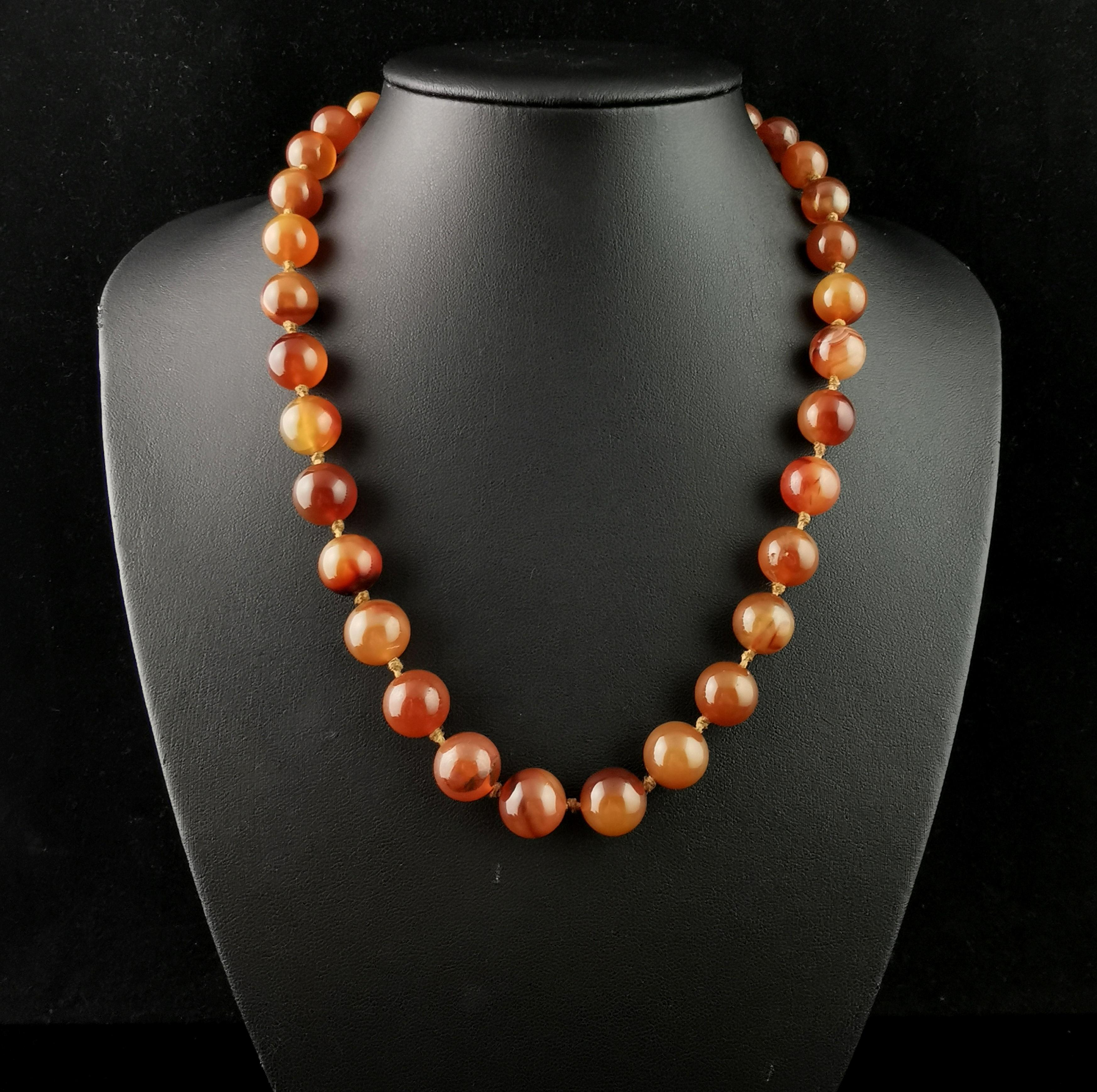 A beautiful antique agate bead necklace.

Slightly graduated rich Carnelian beads with swirling tones of deep red to orangey red make up this lush necklace.

The beads are spherical in shape, each hand carved and polished and strung onto a cotton