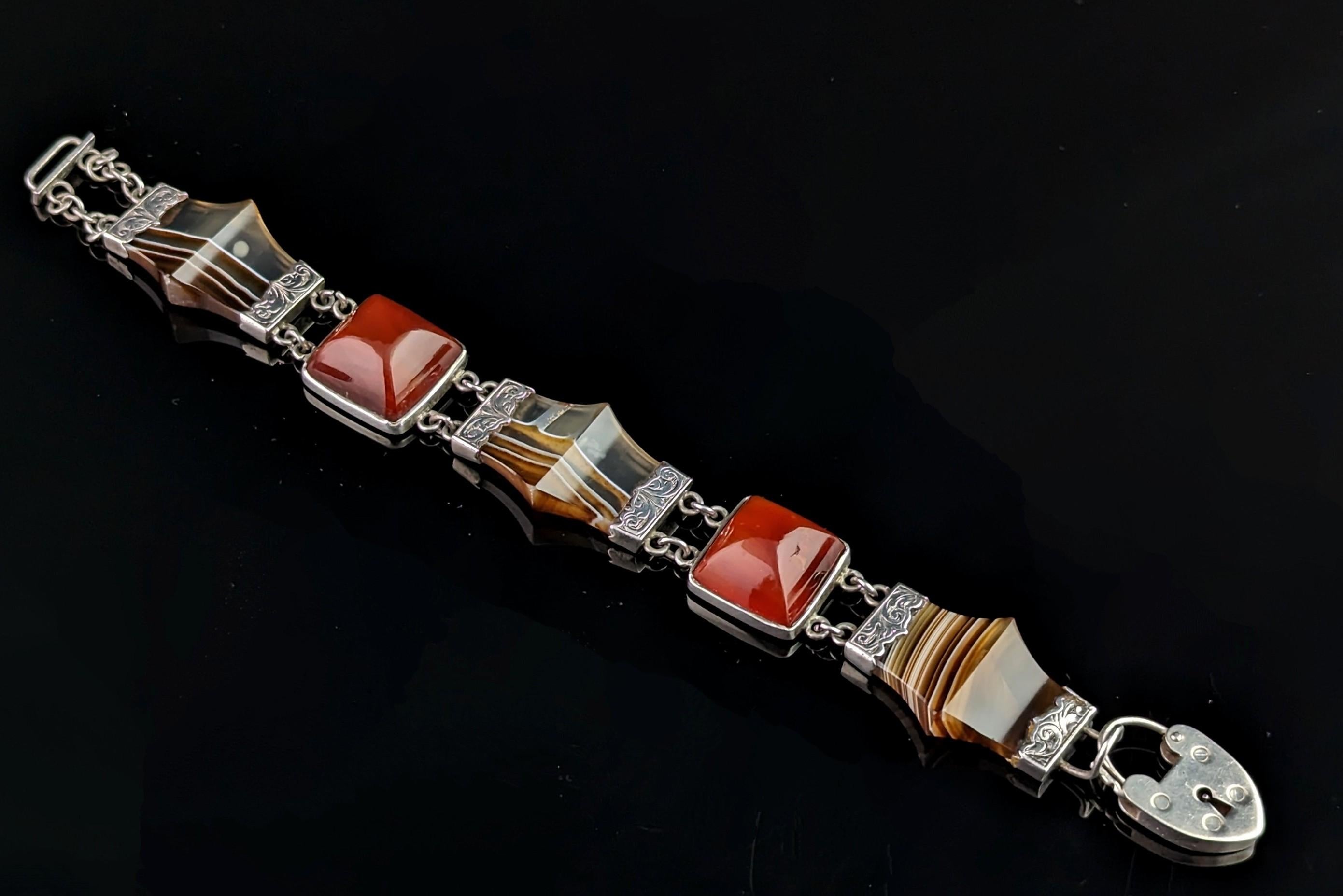 This stunning antique, mid Victorian era Scottish agate and Silver bracelet is really something else.

The bracelet features beautifully faceted panels of polished banded agate each with engraved silver end caps, each of these is intercepted by fine