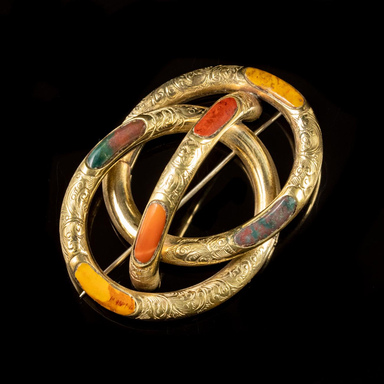 This beautiful Antique Victorian brooch has been commissioned in Pinchbeck gilded in Yellow Gold to form the shape of a knot, known as a Lover’s Knot. The brooch is further adorned with six pieces of beautiful Scottish Agate and engraved with