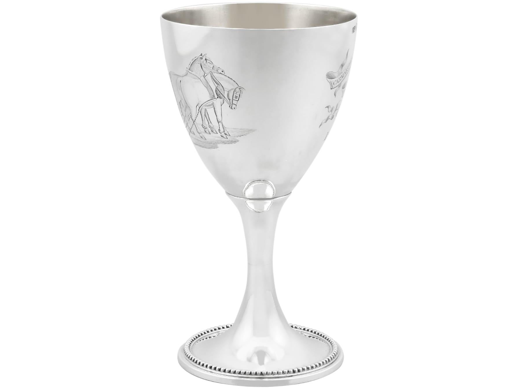 An exceptional, fine and impressive antique Victorian English sterling silver engraved goblet; an addition to our collection of wine and drinks related silverware.

This exceptional antique Victorian sterling silver goblet has a circular bell-shaped