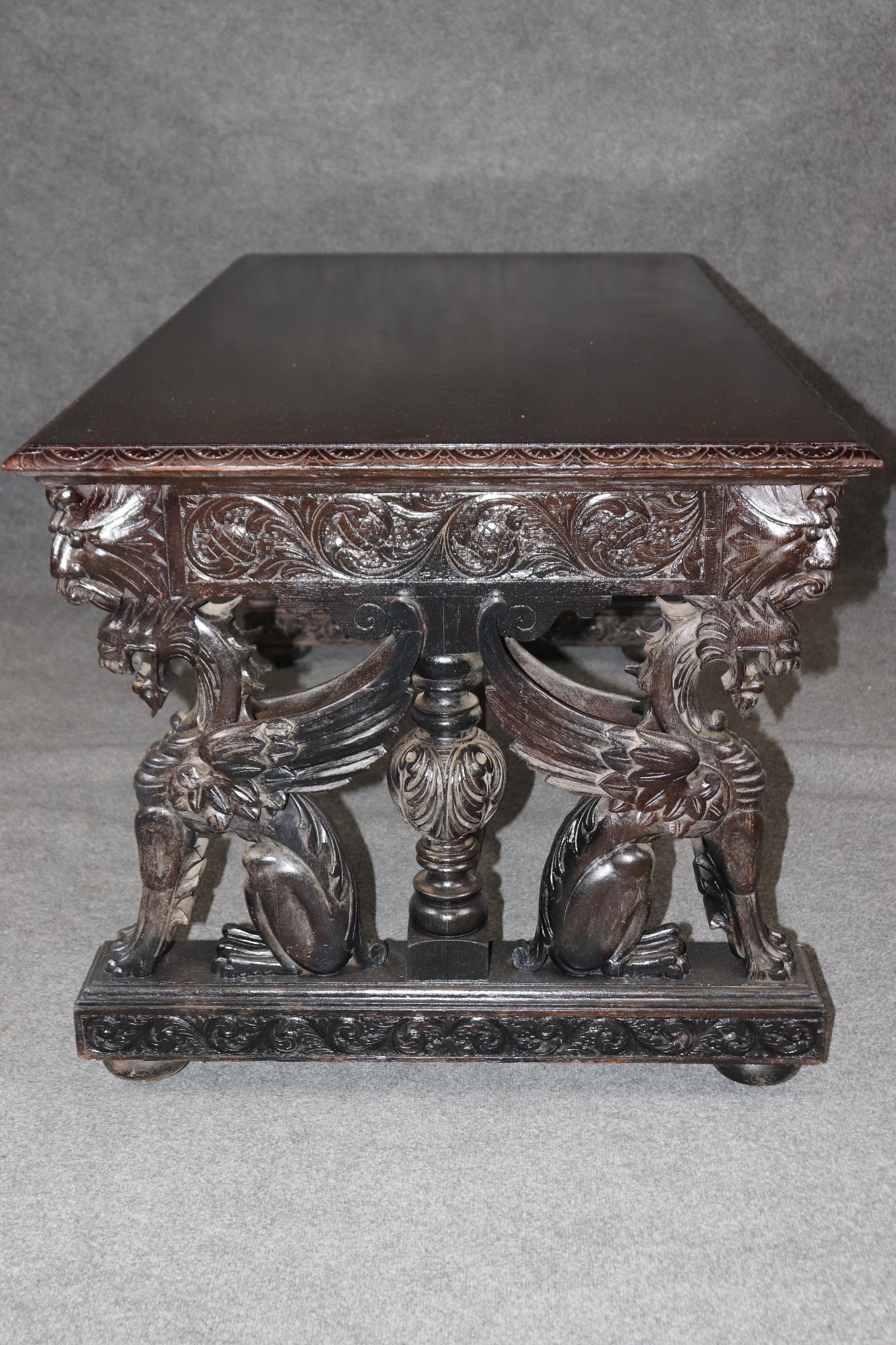 This is a spectacular R.J. Horner attributed writing or libray table. The desk features robust, precise carving of griffons and various floral elements. The desk wear its original finish, flaws included and is in good antique conditon. The desk is