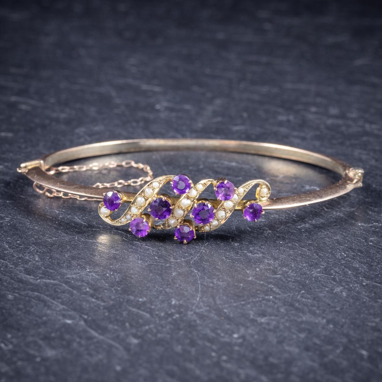 A beautiful antique Victorian bangle C. 1900, featuring a fabulous front gallery adorned with violet Amethyst and natural fresh water Pearls. 

The larger two Amethyst are approx. 0.20ct each with smaller 0.18ct Amethyst across the gallery. 

The