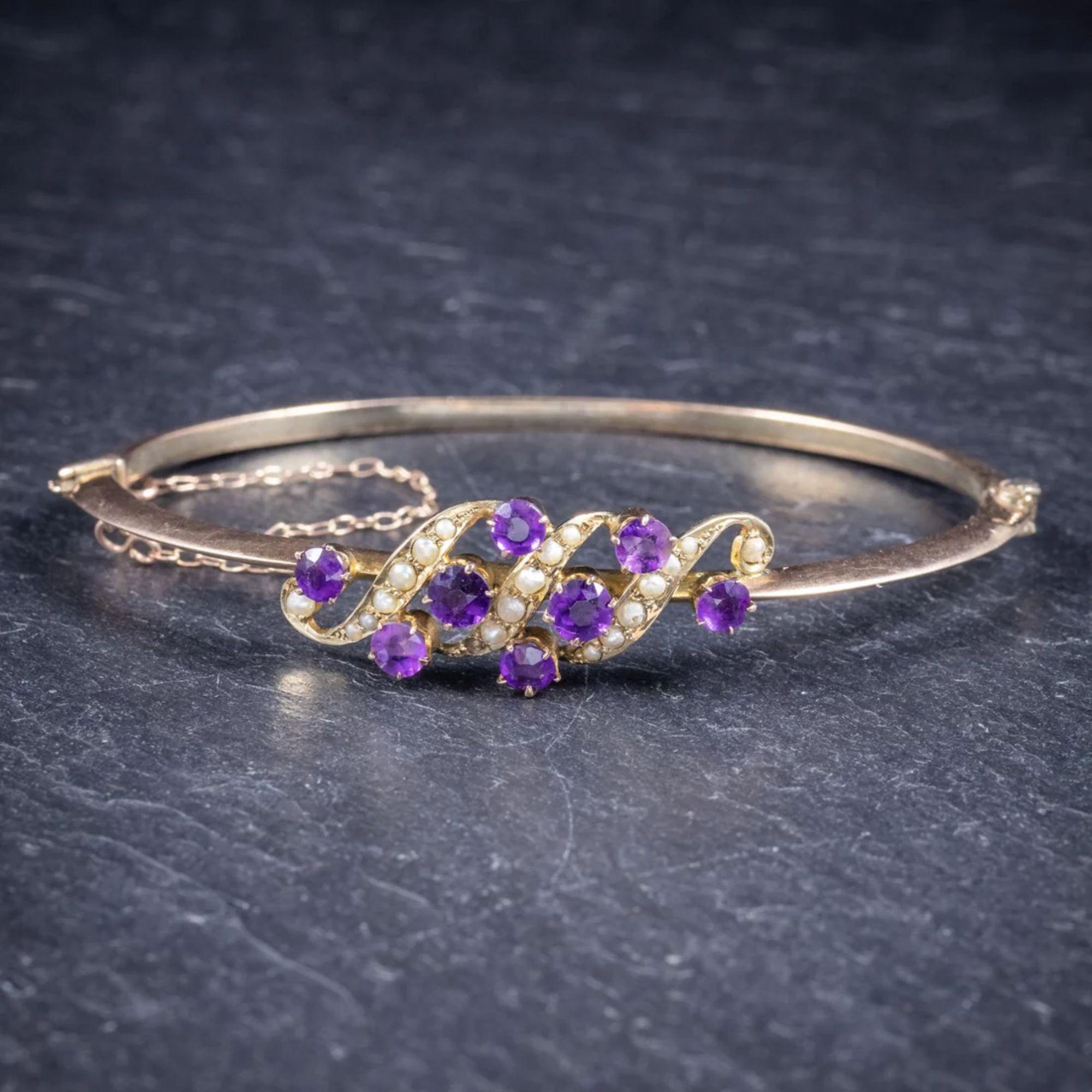 A beautiful antique Victorian bangle (C. 1900), featuring a fabulous front gallery adorned with violet Amethysts and natural fresh water Pearls.

The larger two Amethyst are approx. 0.20ct each with smaller 0.18ct Amethyst across the gallery.

The