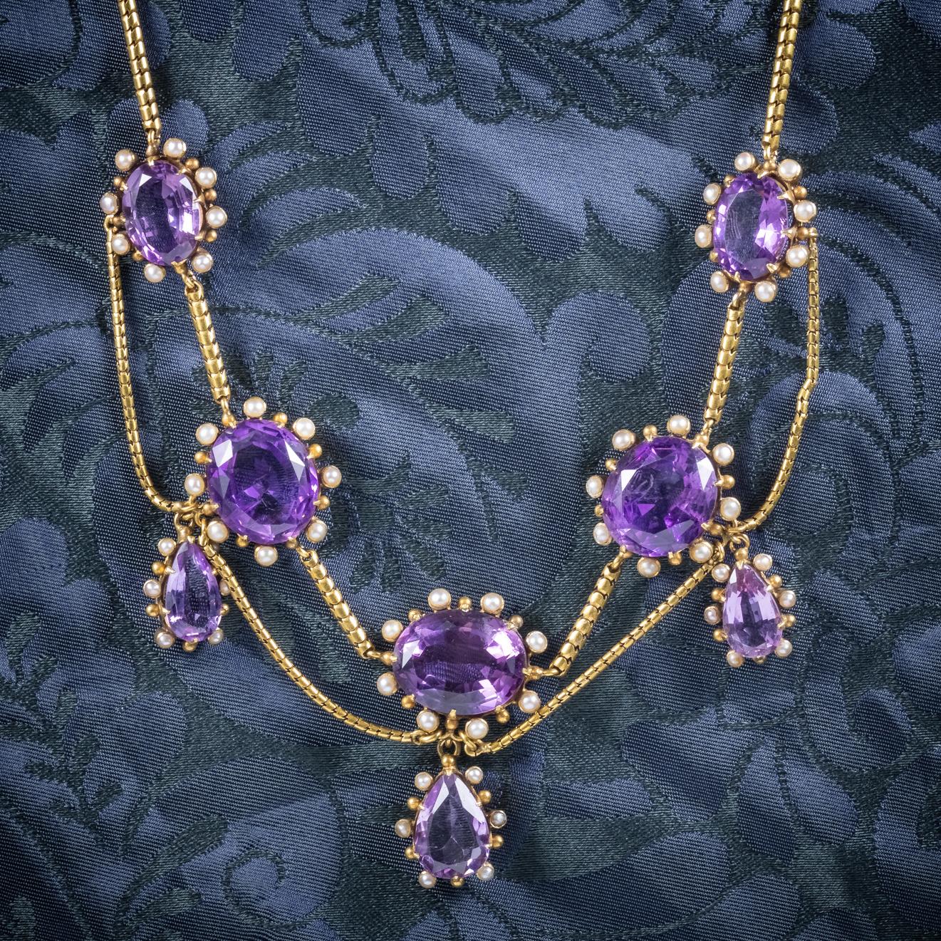 A stunning antique Victorian Garland necklace C.1860, adorned with approx. 60ct of beautiful deep purple Amethyst which are encircled by natural Pearls. 

There are five lovely oval Amethyst which dangle from a festoon chain leading to three