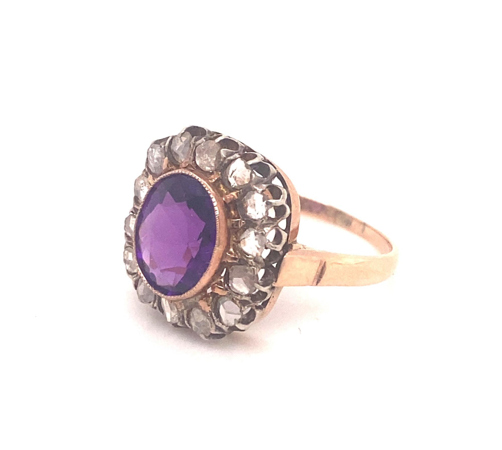 This is a beautiful antique Victorian ring with an oval shaped amethyst and rose cut diamonds. The diamonds are set in silver and the ring is 18K yellow gold.  The amethyst is oval shaped with amazing color and clarity approximately 3.0 carats.