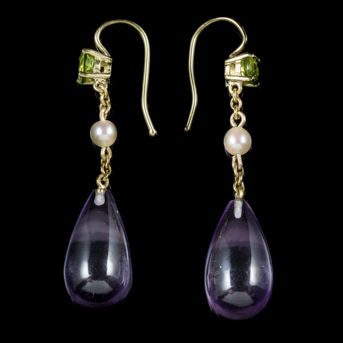 These fabulous antique Victorian Amethyst drop earrings were made representing the Suffragette movement, Circa 1900.

Suffragettes liked to be depicted as feminine, their jewellery popularly consisted of Violet, Green and White colours which were