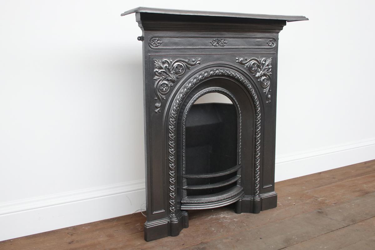 Victorian arched cast iron bedroom fireplaces. This design was first registered in May 1873 and protected for a further 3 years, dating this fireplace between 1873-1875.

The fireplace has been finished with traditional black grate polish and is