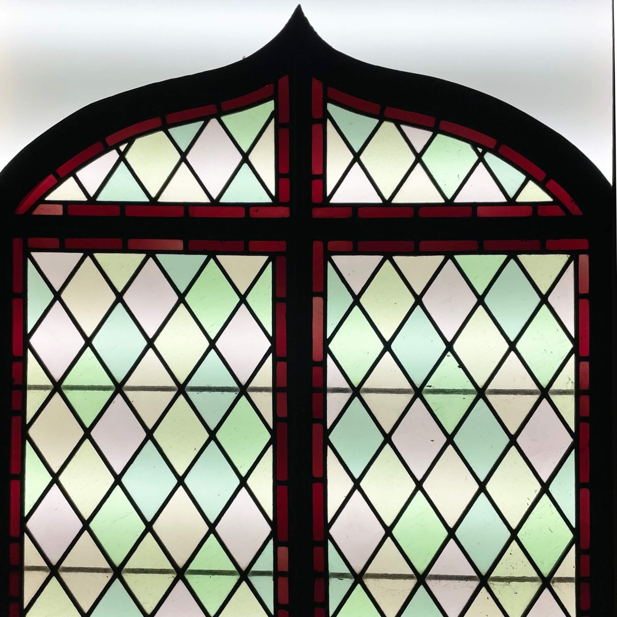 An antique Victorian stained glass arched window dating to circa 1890. This simple yet elegant English piece of artistry is of a lattice pattern and an unusual pointed arch top, showcasing a classic attractive design.

The colours would soon be