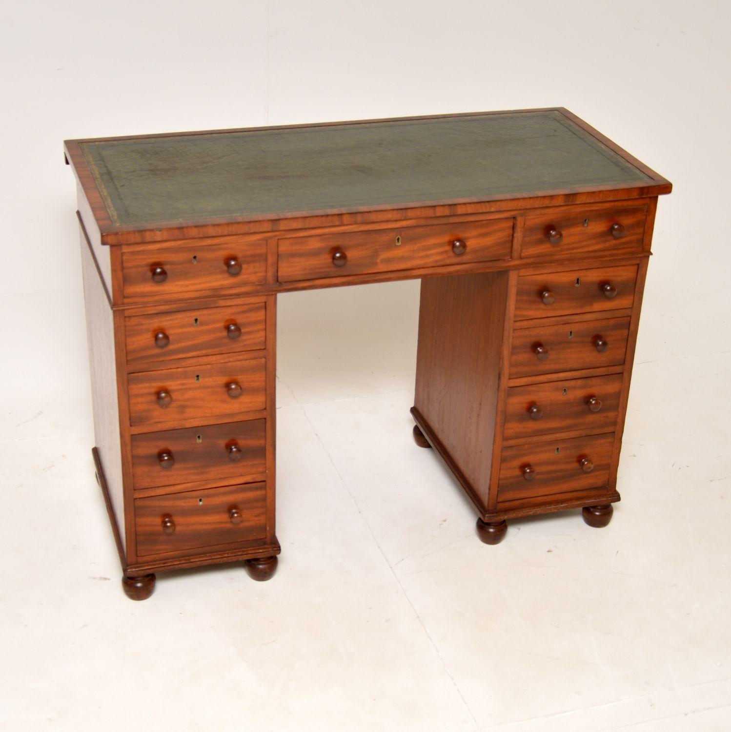 A beautiful and very unusual antique early Victorian architects desk. This was made in England, and I would date it from the 1840-1860 period.

It appears as a regular pedestal desk with a gold tooled leather top, turned handles and bun feet.