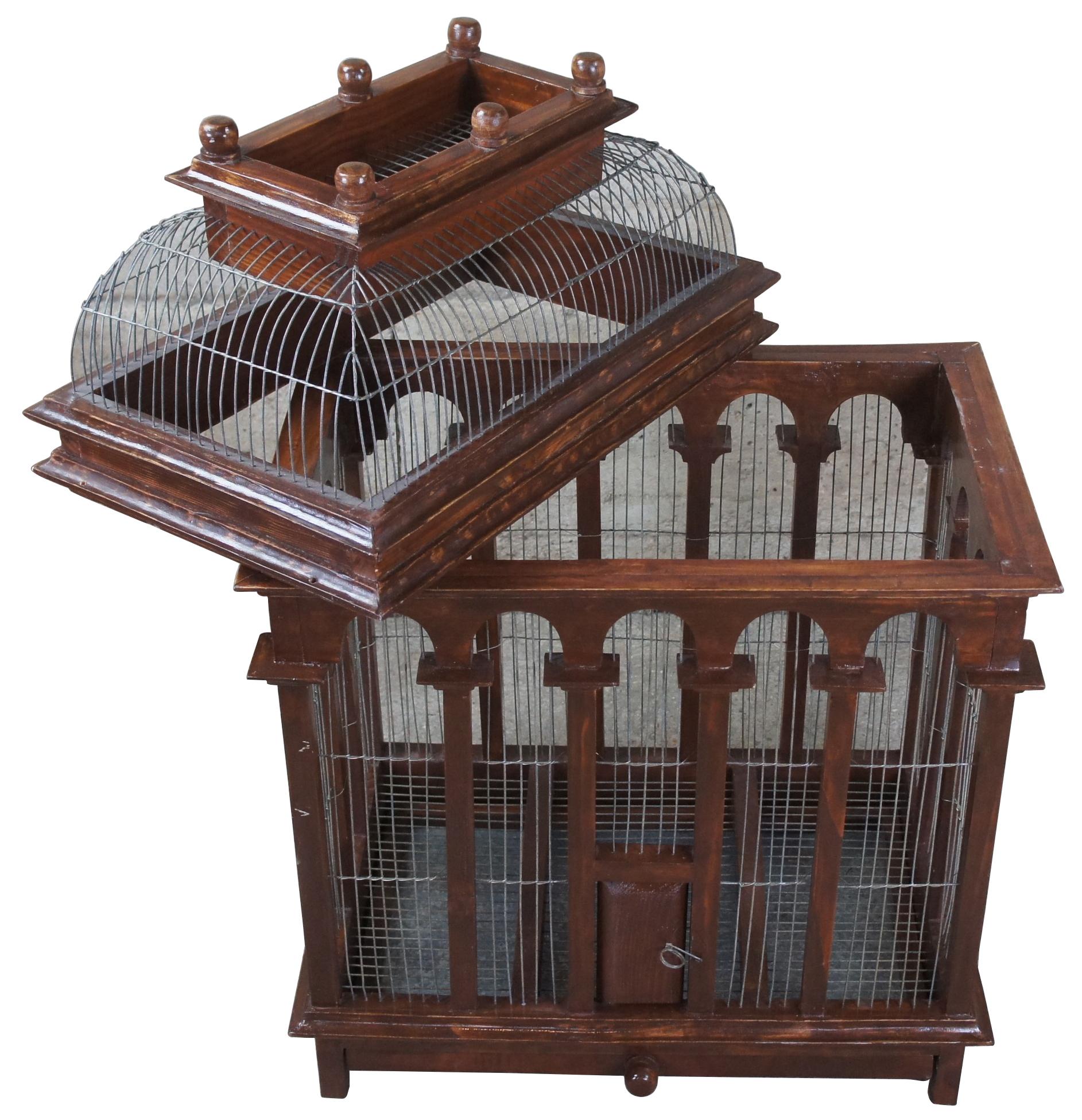 Victorian architectural carved birdcage. Perfect for birds or the display of airplants, succulents and moss. Made out of wood and wire with front door, sliding tray on bottom for cleaning and removable dome top. Mesure: 34