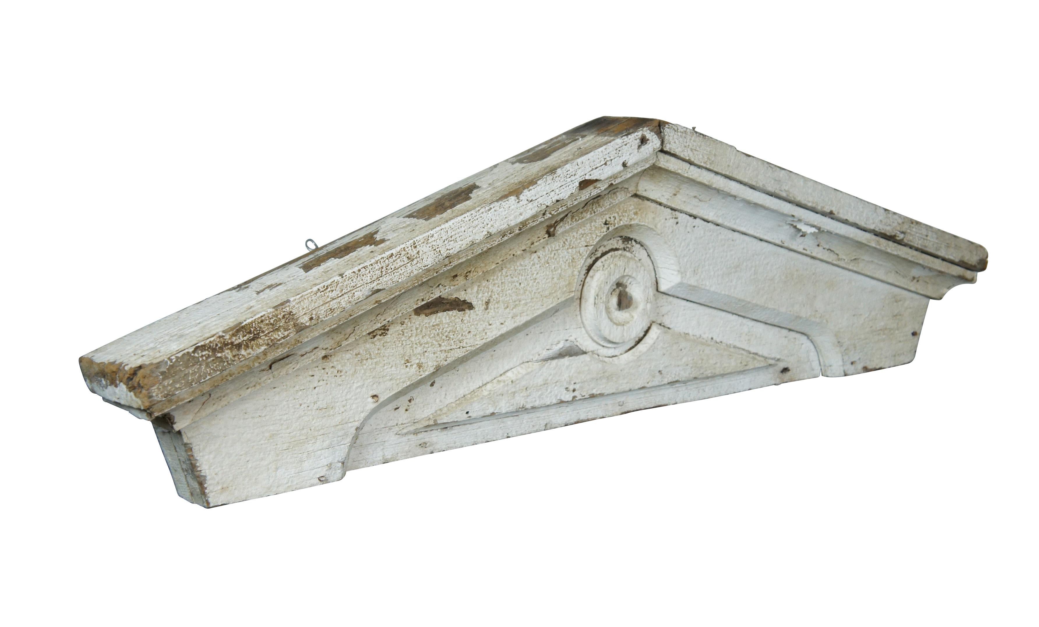 Antique Victorian architectural salvaged wooden farmhouse window or door pediment, lintel or header. Painted white; simple peaked design with beveled bulls eye detail. Fitting with two hooks for wall display.

Dimensions:
48