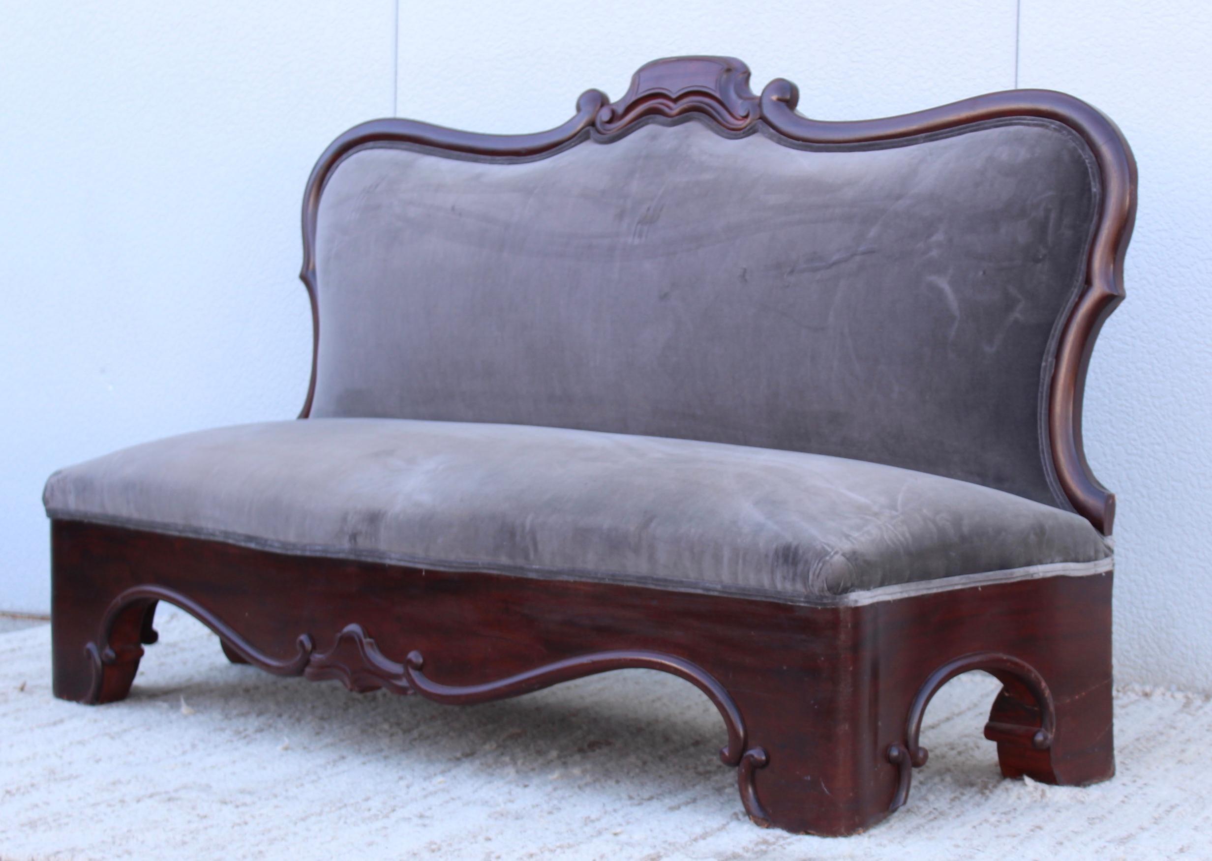 Antique Victorian armless loveseat in velvet, in vintage original condition with some wear and patina, it needs refinishing and new upholstery.