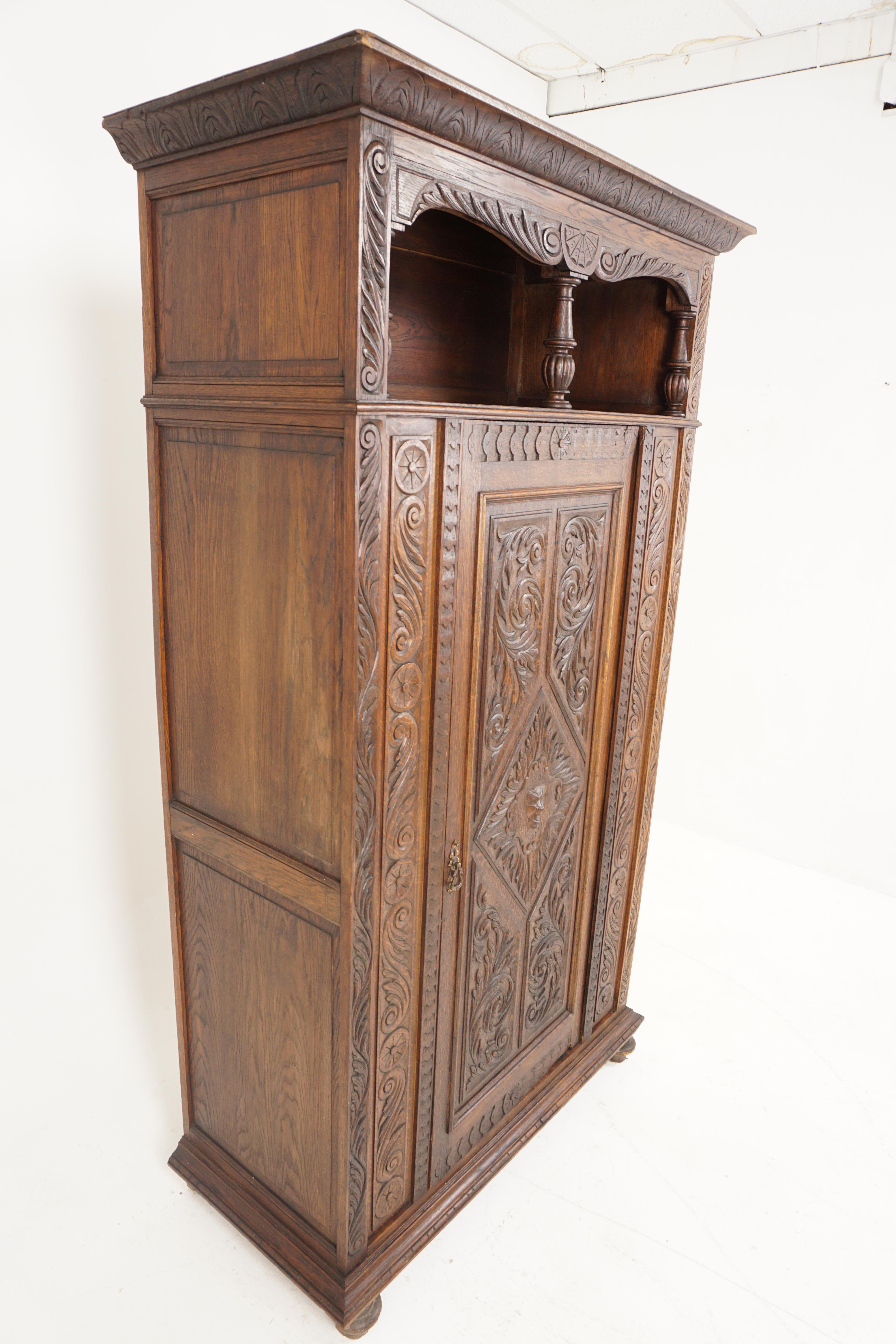 Antique Victorian armoire, carved oak, hall wardrobe, Scotland 1870, B2637

Scotland 1870
Solid oak
Original original finish.
Carved moulded cornice.
Open shaped cupboard below.
With three turned spindles to the front.
Single carved door