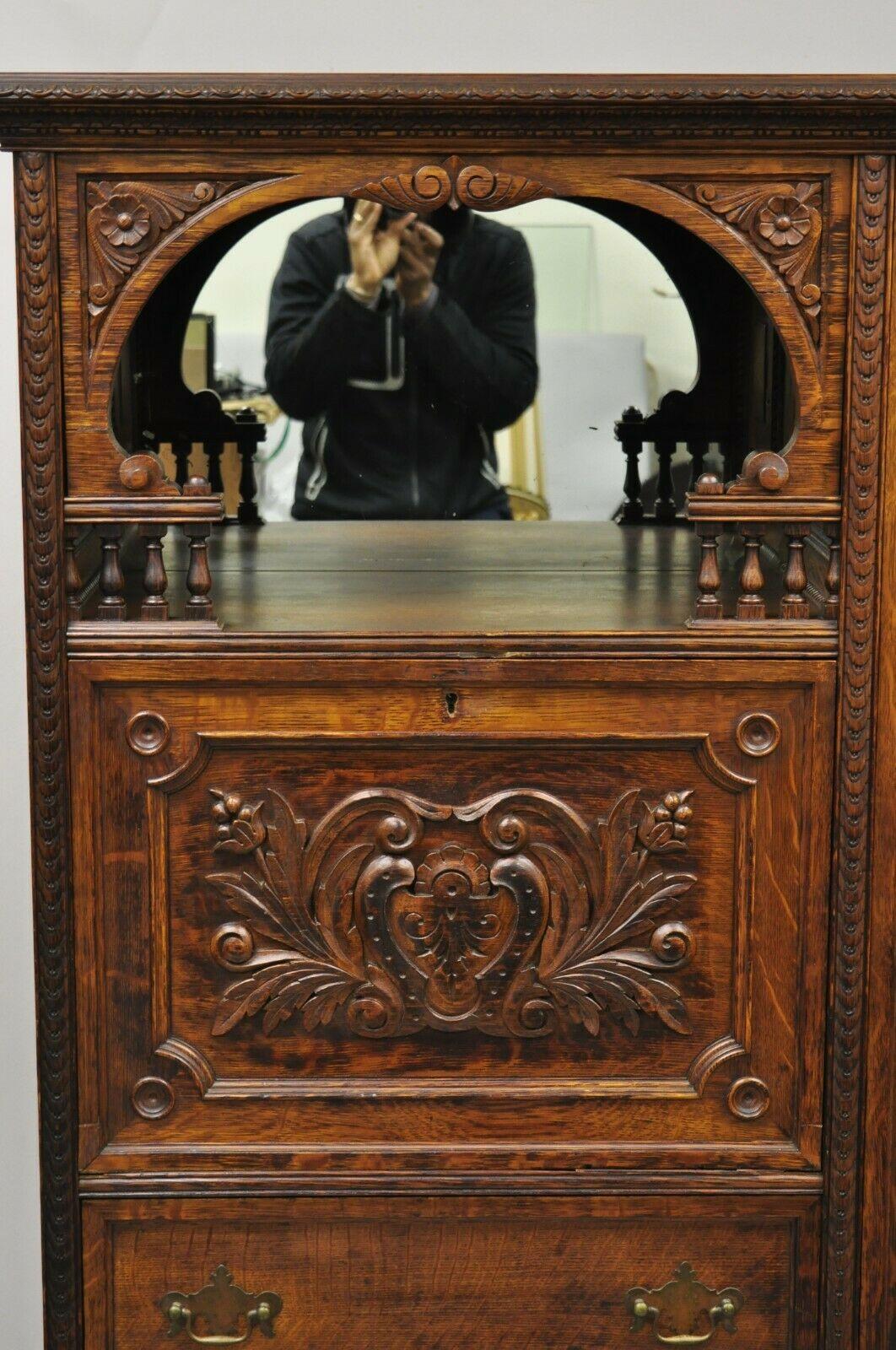 Antique Victorian Art Nouveau carved oak wood secretary desk book case. Item features fall front secretary desk with fitted interior (Does not have metal hinge so currently must rest on open top drawers (see pic 7). Mirror back, solid wood