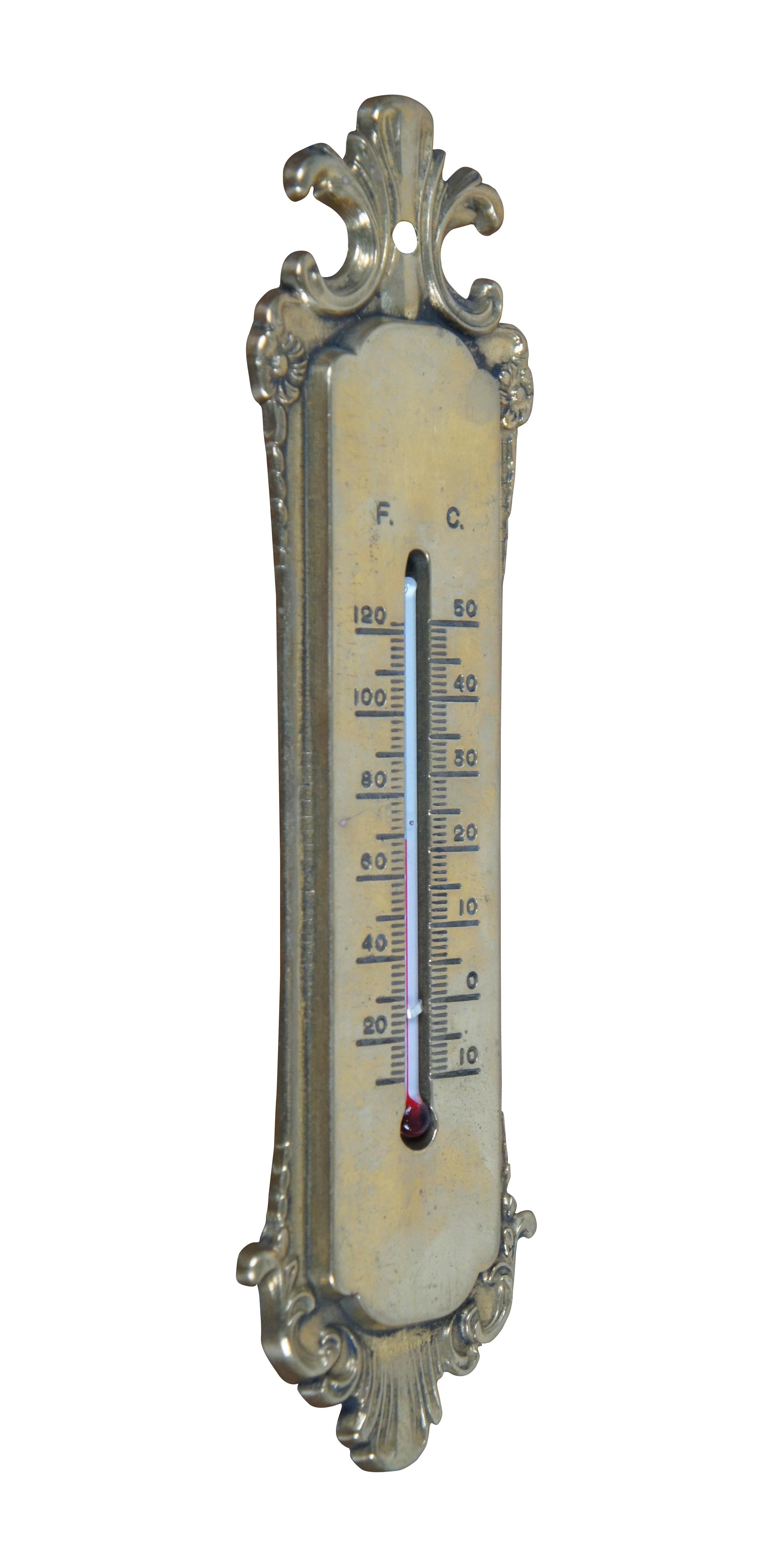 Late 19th century Victorian brass wall hanging thermometer. Simple art nouveau styling with scallops and flowers. Indicates temperatures up to 120 degrees Fahrenheit and 50 degrees Celsius with standard red-dyed alcohol filled glass