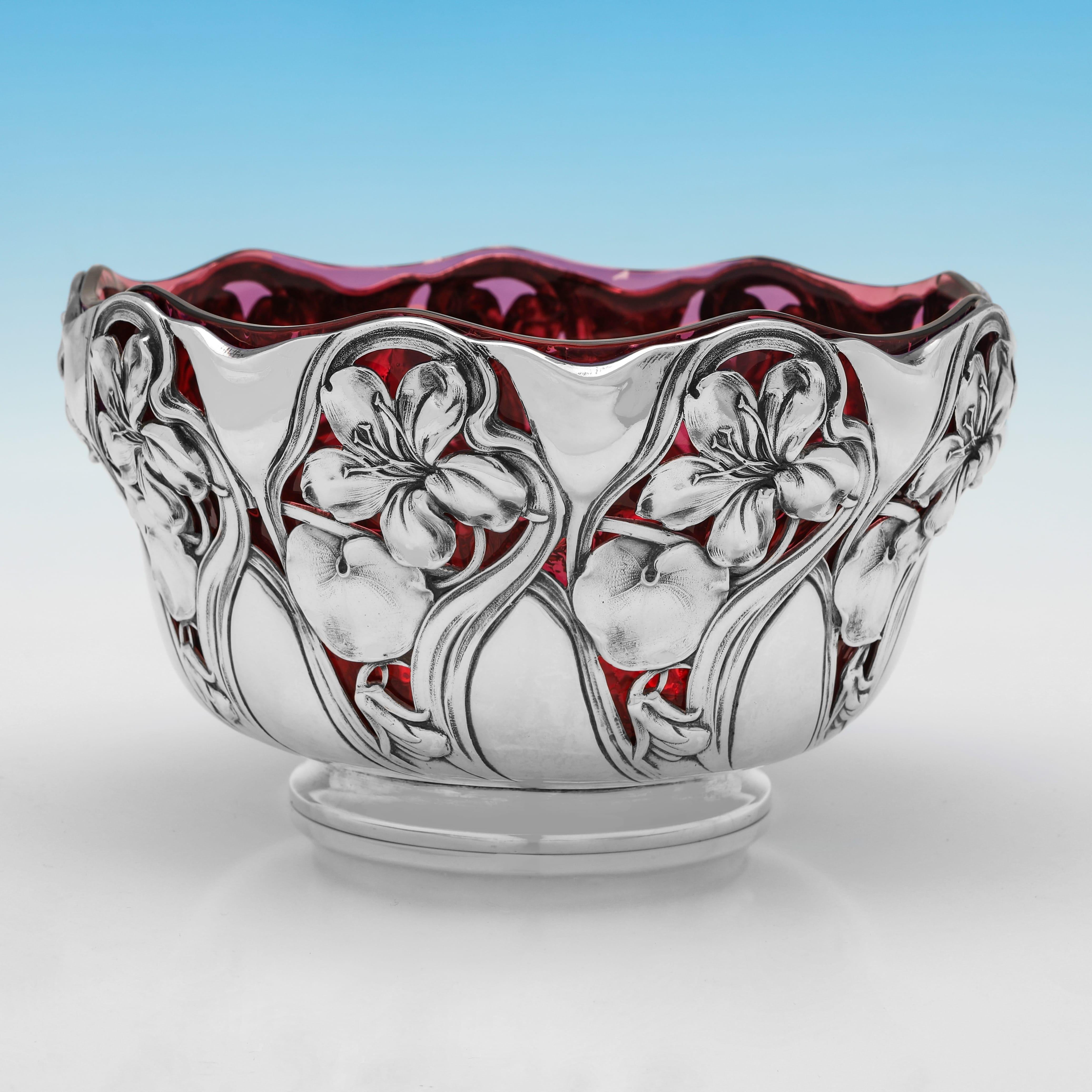 Carrying an import mark for London in 1900 by George Bedingham, this incredibly attractive, Antique, Victorian Sterling Silver Bowl, features a cranberry glass liner, and is in the art nouveau taste, with pierced floral decoration to the body. The