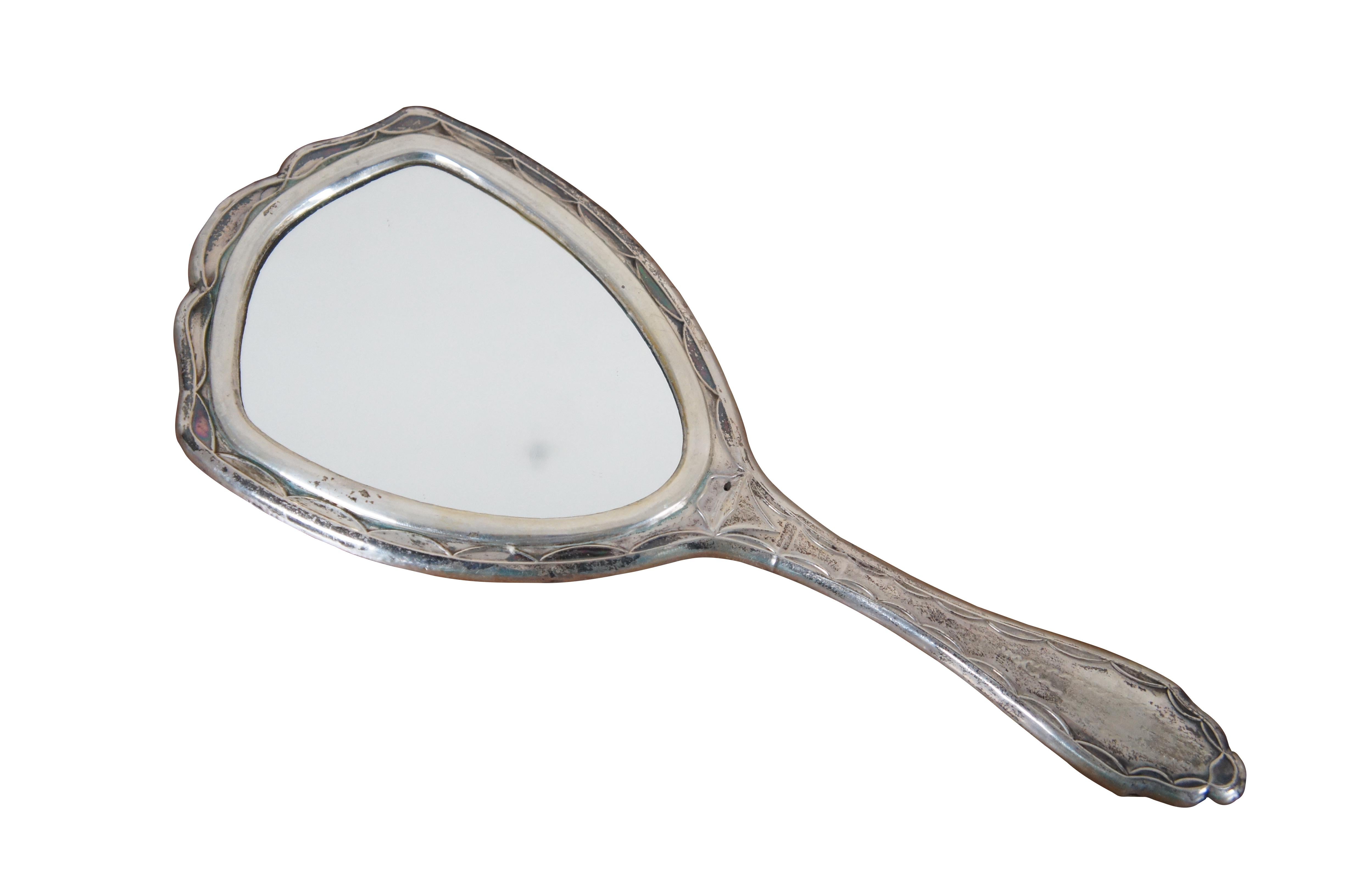 Antique Victorian silver vanity hand mirror featuring Art Nouveau styling with etched floral motif 

Dimensions:
4.25