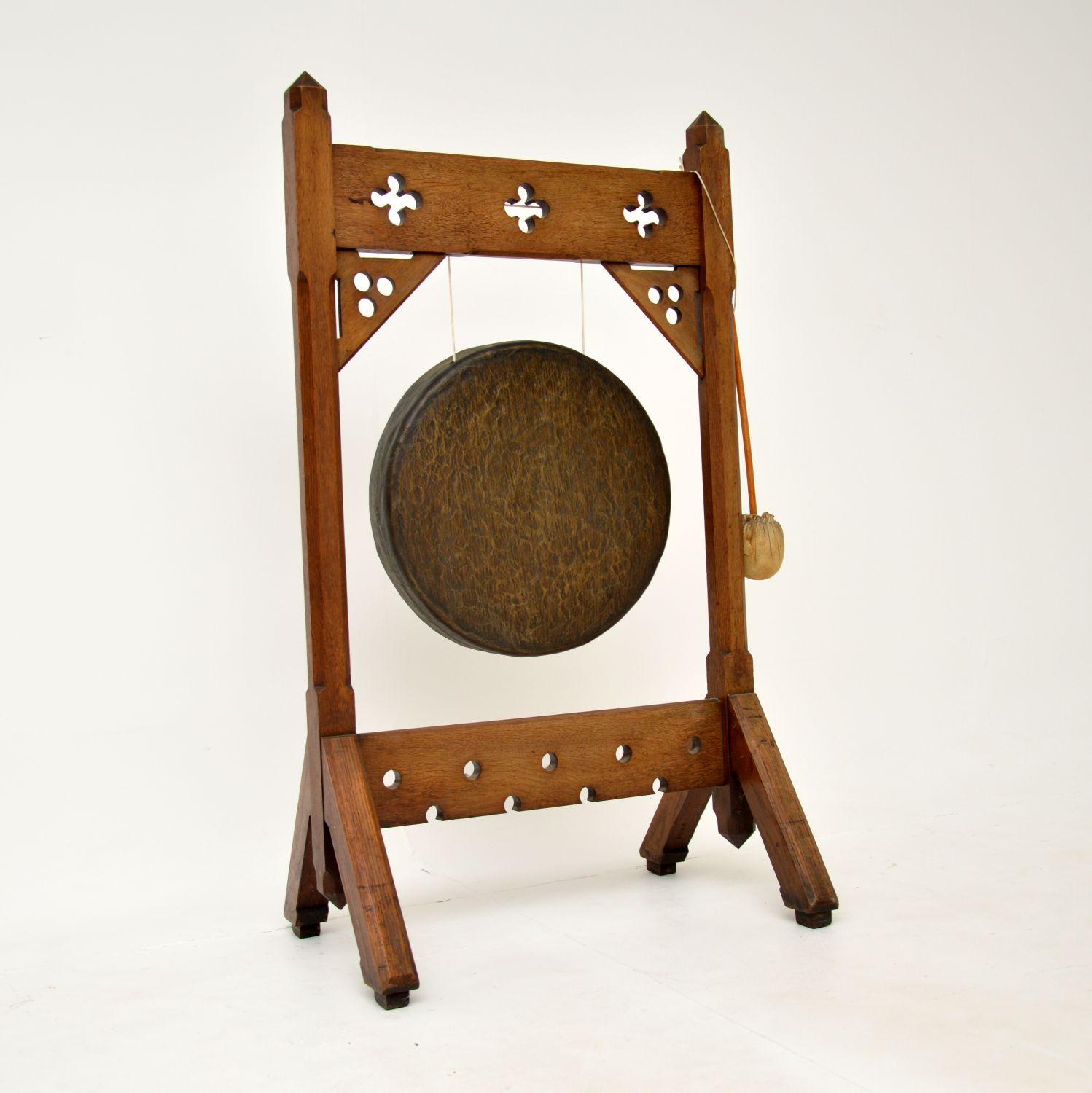 A wonderful antique Gothic Style Victorian Arts & Crafts period dinner gong in solid oak. This was made in England, it dates from around 1880-1890.

It is quite large and very impressive, it makes a lovely sound when beaten. This is from the Arts